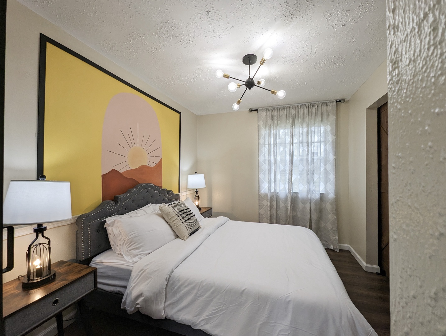 The fourth sunny bedroom includes a cozy queen-sized bed