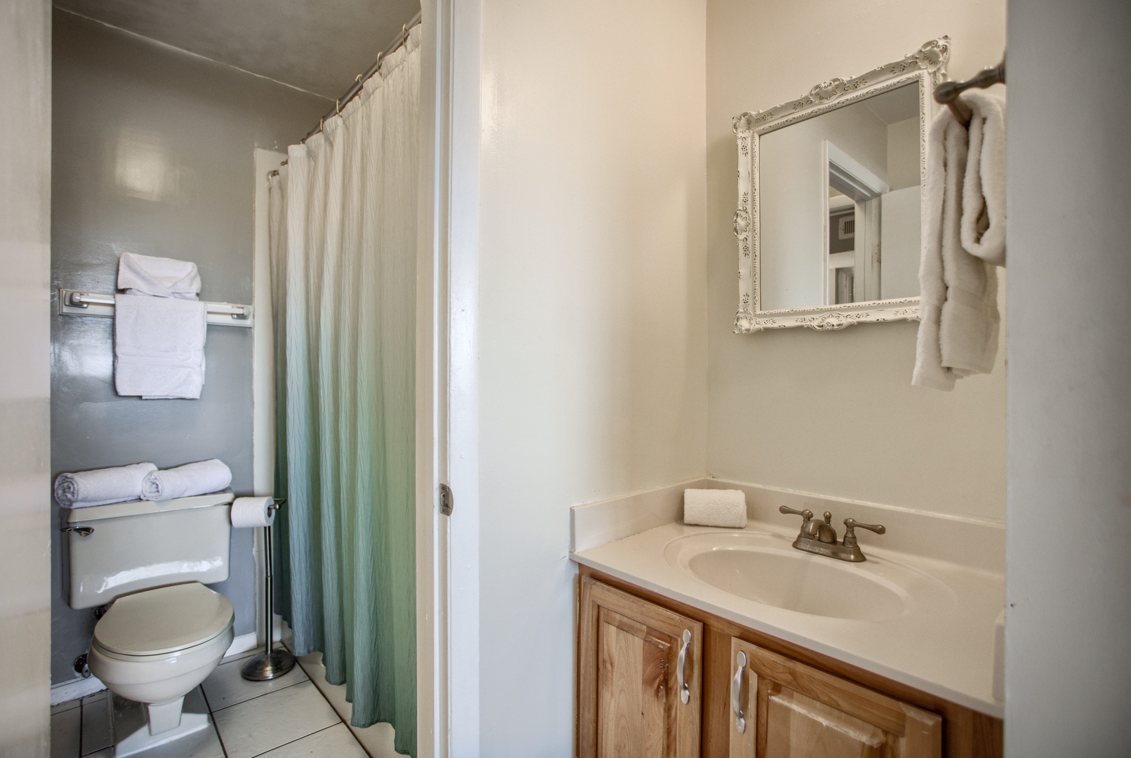 Serene Connected Bathroom with Single Vanity and Shower/Tub Combo