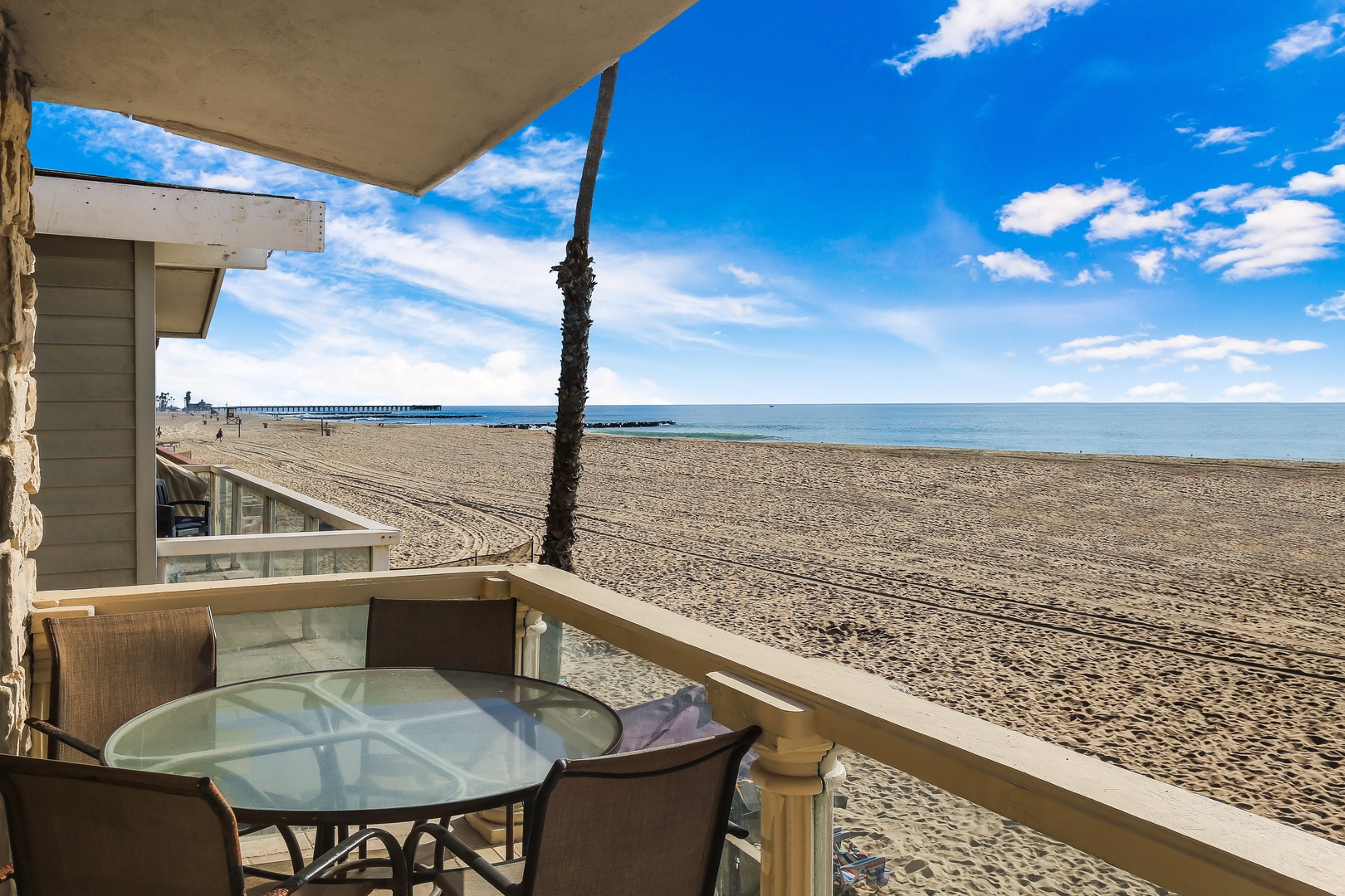Beachfront balcony with seating and BBQ