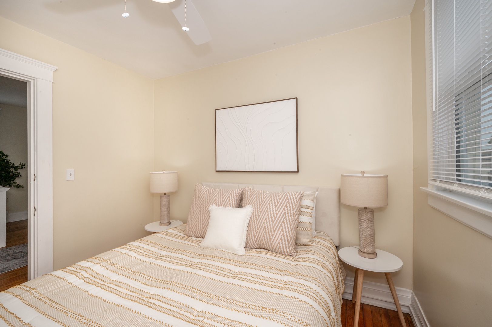 The 2nd of 3 bedrooms offers a queen bed & ceiling fan