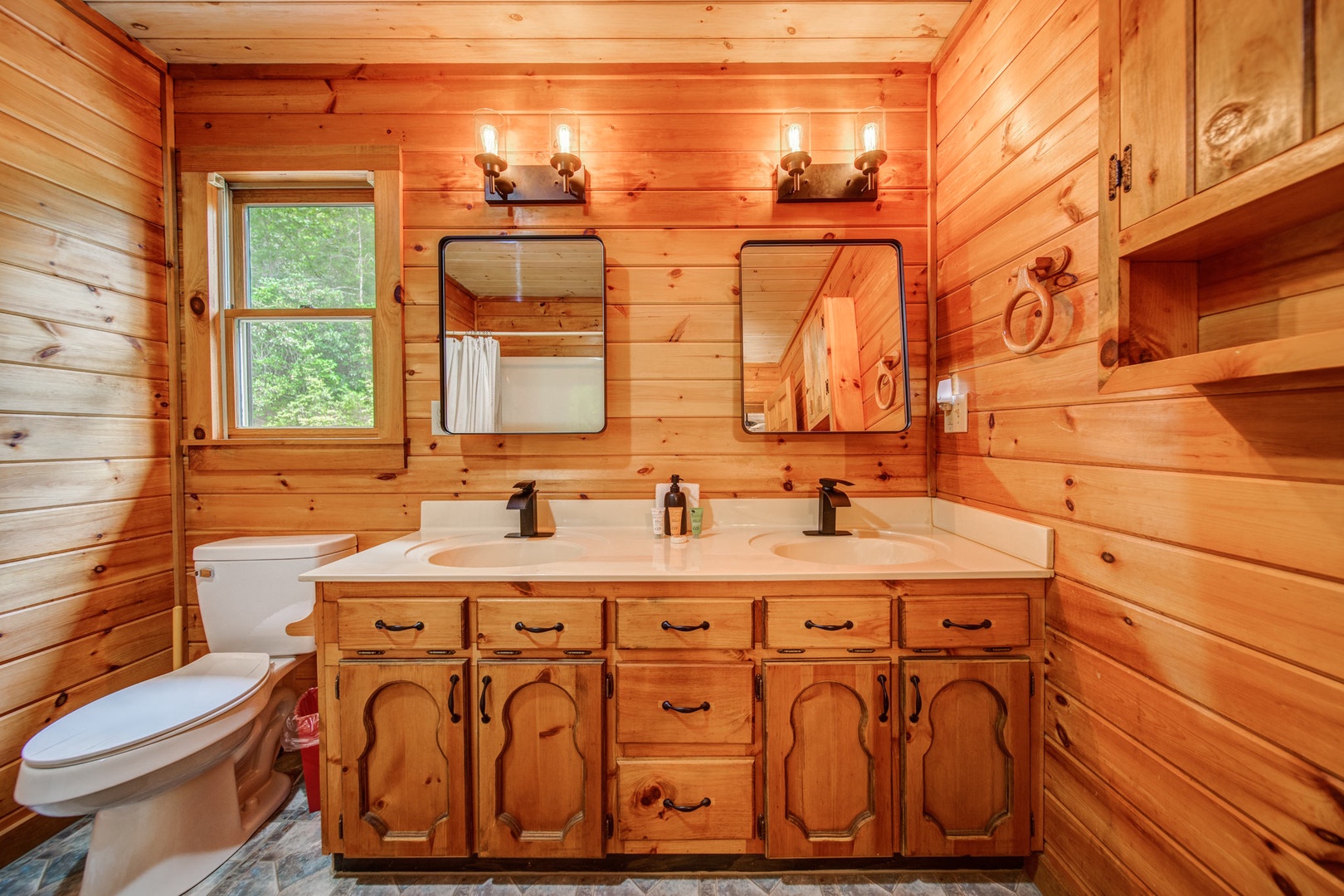 The loft-level bathroom offers a double vanity & walk-in shower