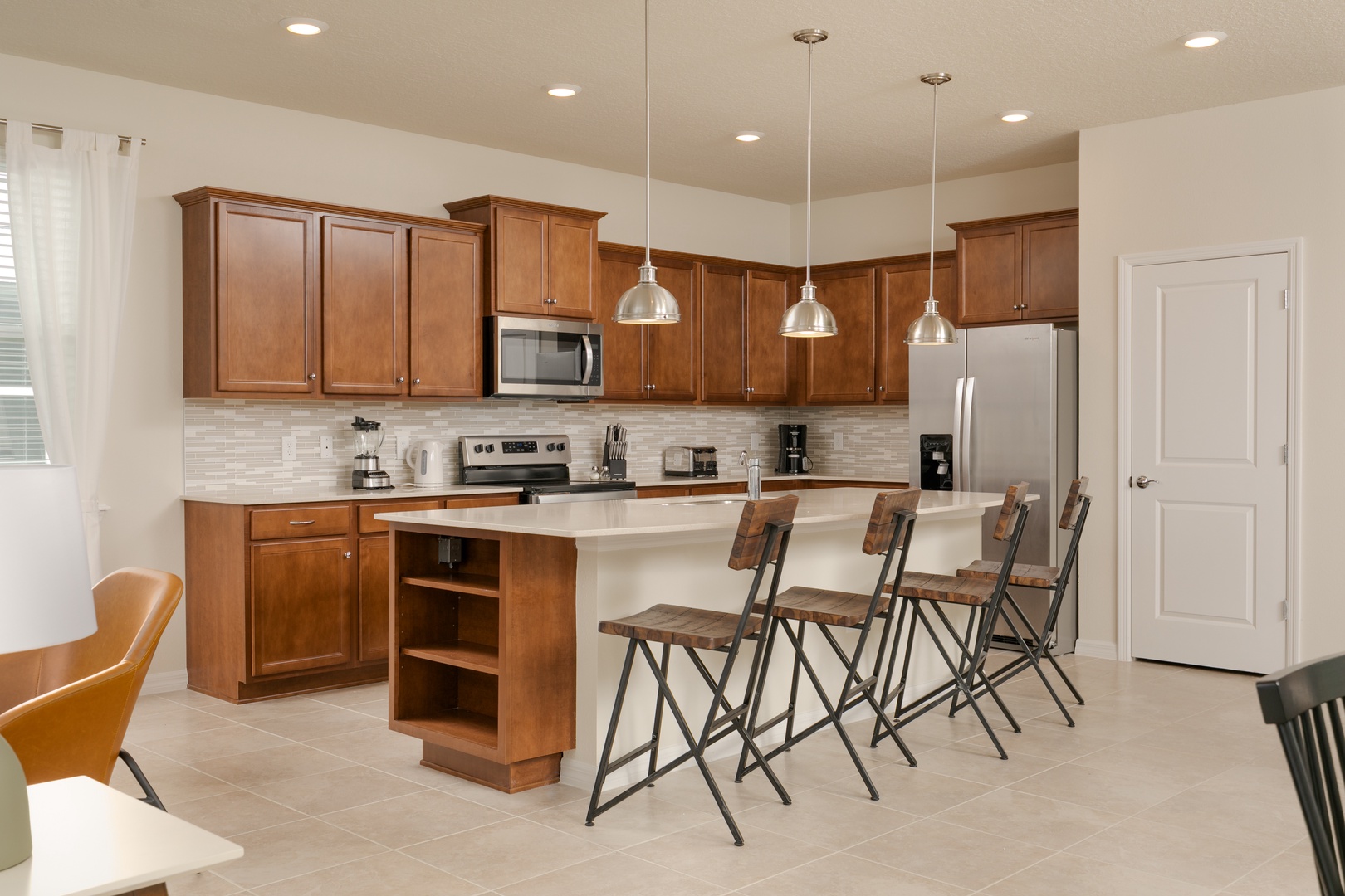 The gorgeous kitchen is fully equipped with all the comforts of home