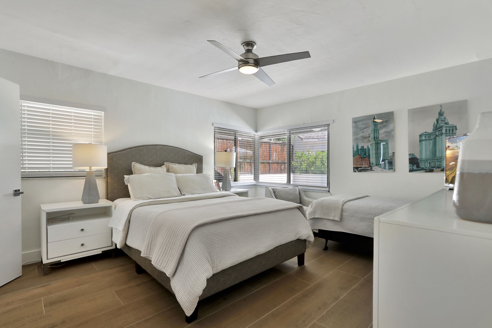 The second bedroom includes a queen bed, twin bed, ensuite, & smart TV