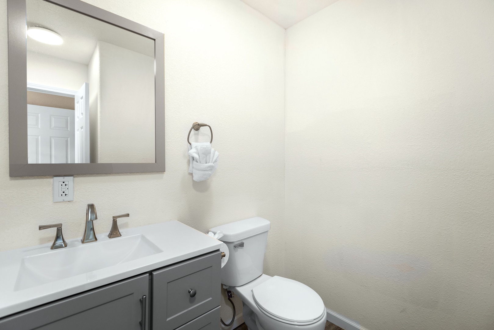 This full bathroom includes a chic single vanity & walk-in shower