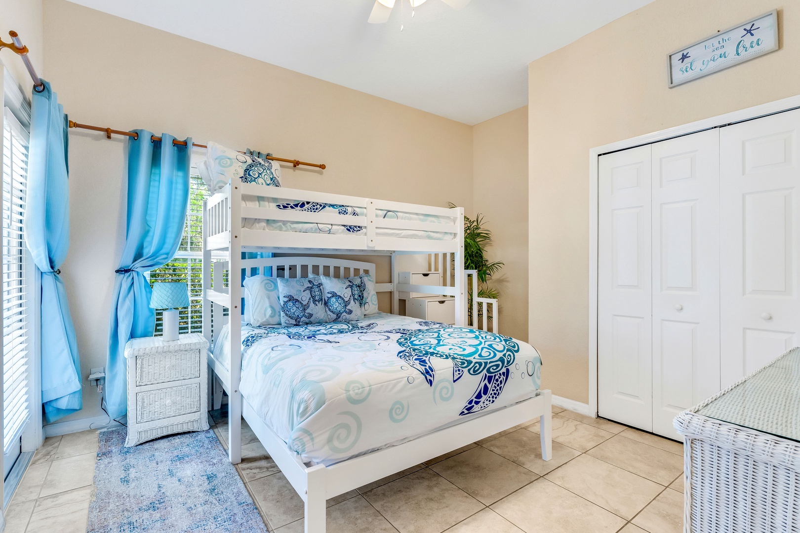 The 1st suite features a twin-over-queen bunkbed, ensuite, TV, & patio access