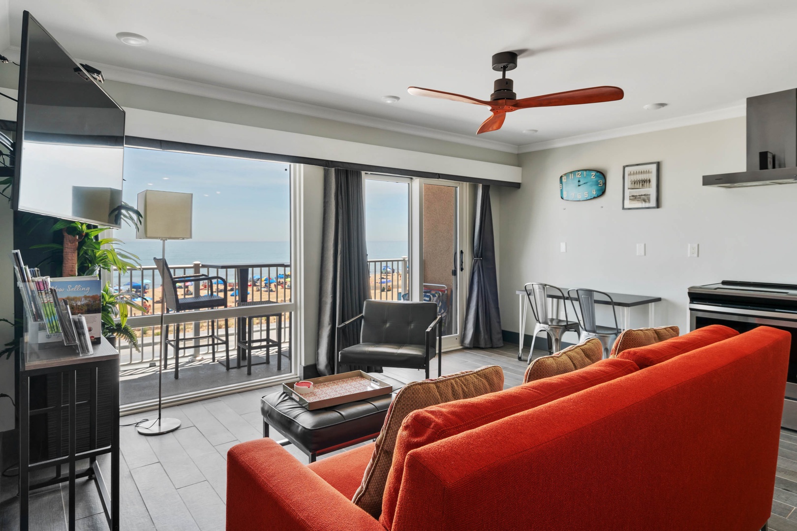 Living room with sofa sleeper, TV, and balcony