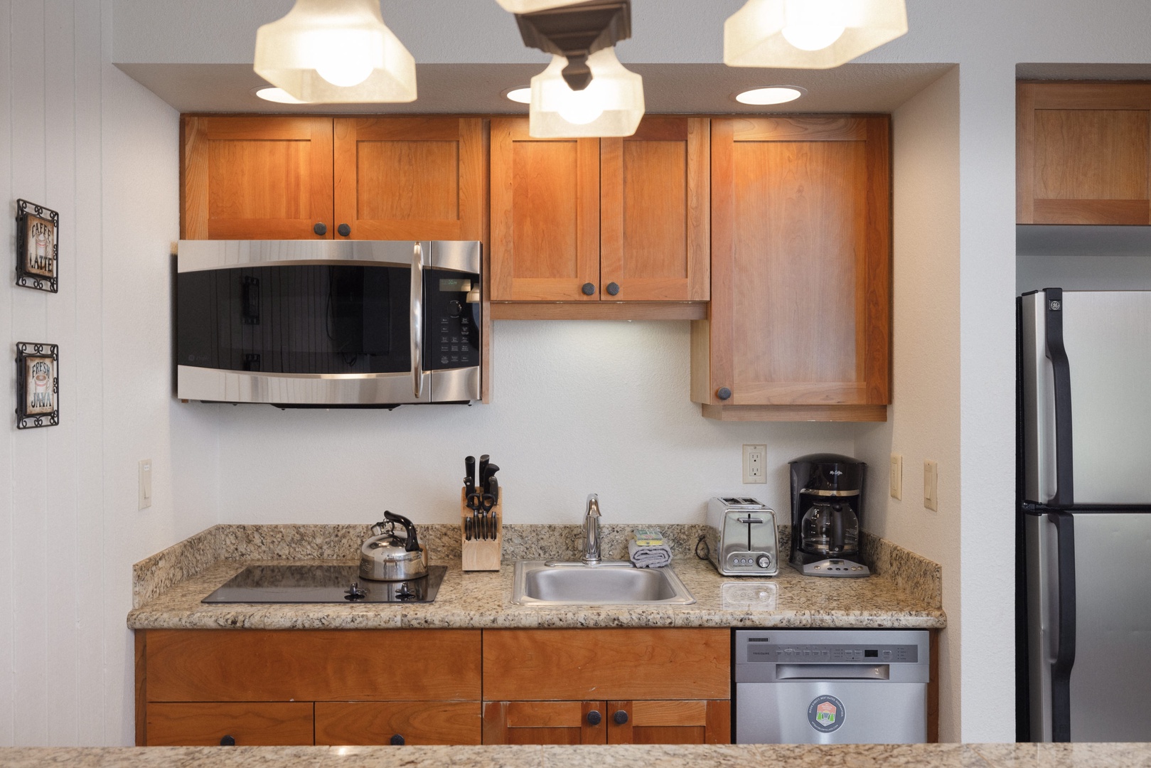 A compact yet functional kitchen with modern appliances and granite countertops