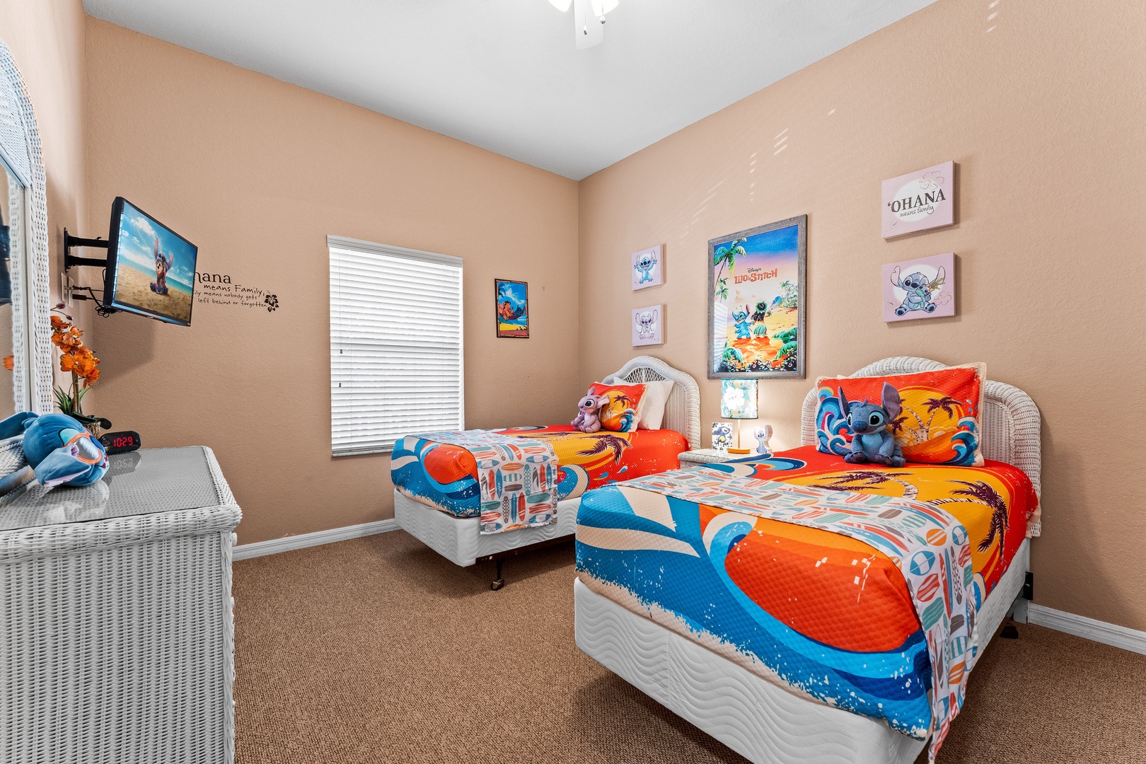 Lilo & Stitch-themed bedroom with two twin beds and a ceiling fan