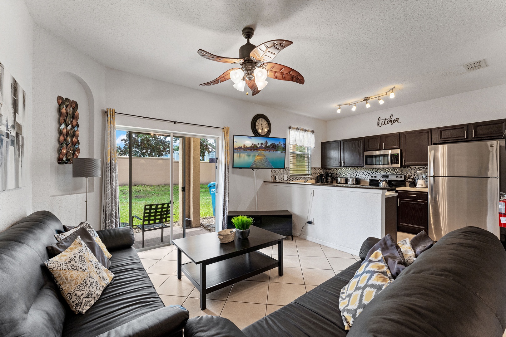 Bright living area with cozy seating, Smart TV, and patio