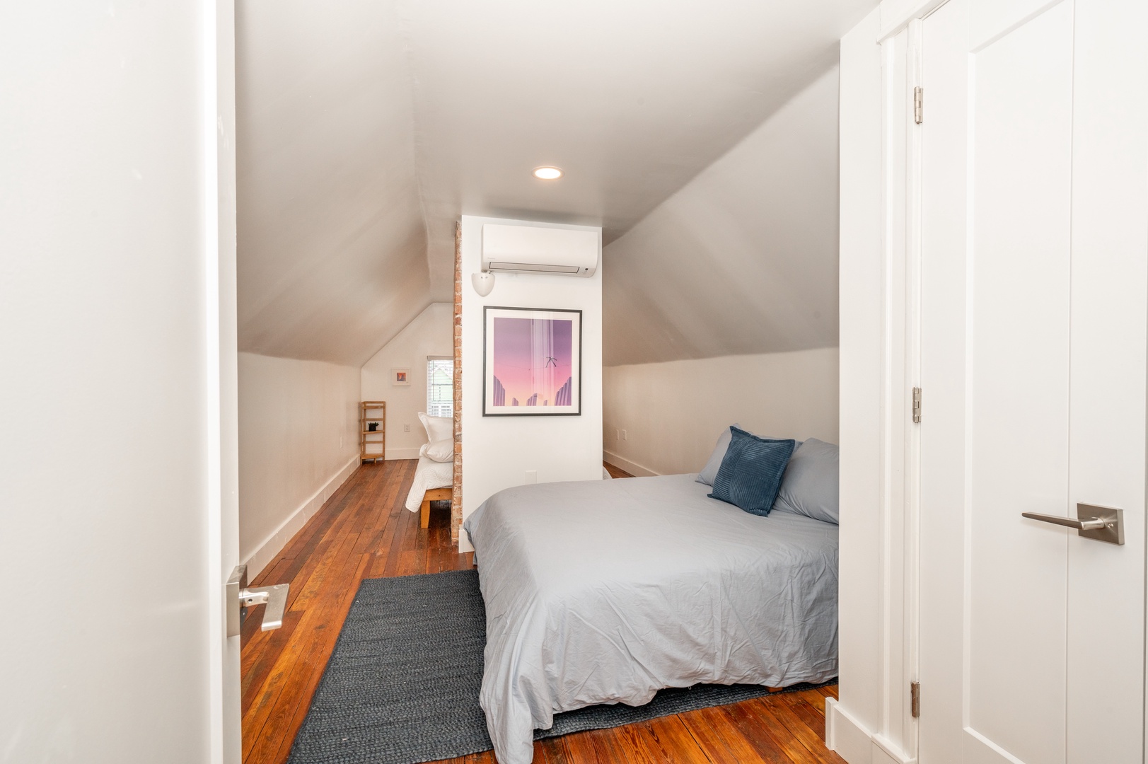 A pair of cozy queen-sized beds are available in this 3rd-floor bedroom