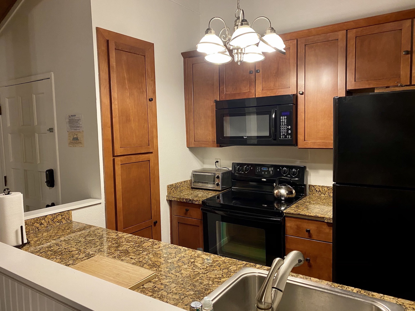 Fully equipped kitchen with electric stovetop, toaster oven and more