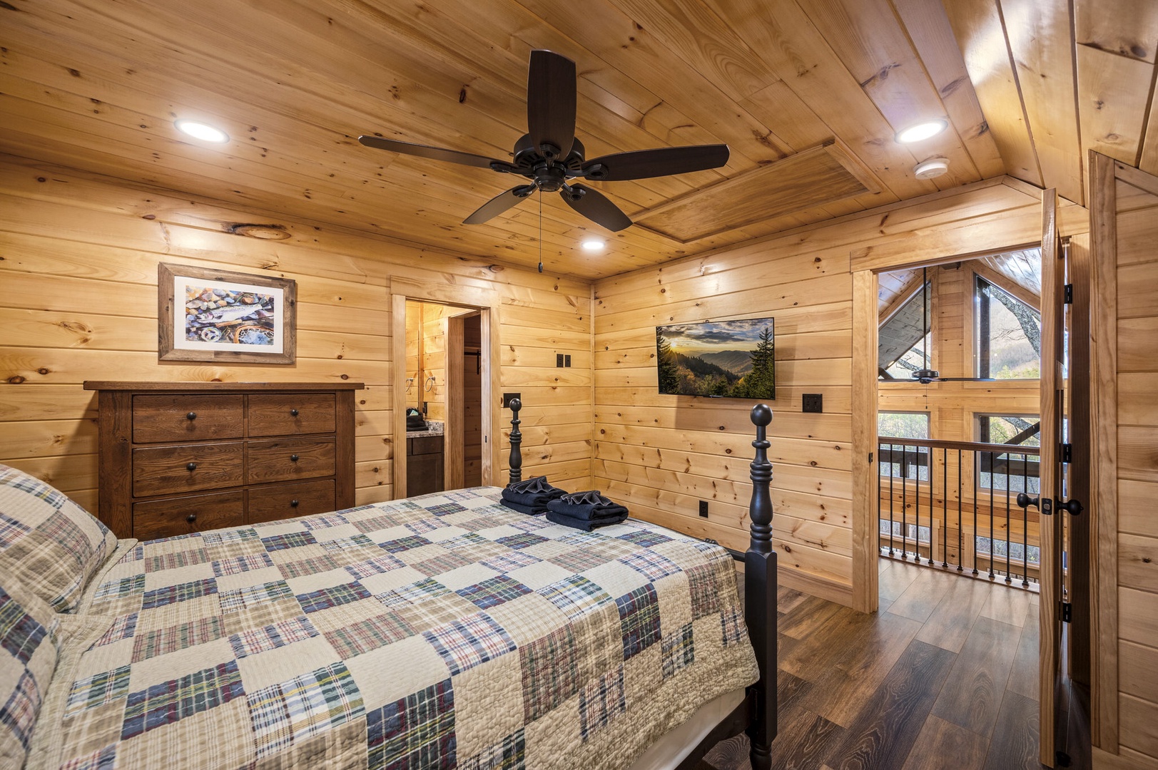 Bedroom 2 with queen bed, TV, and ensuite