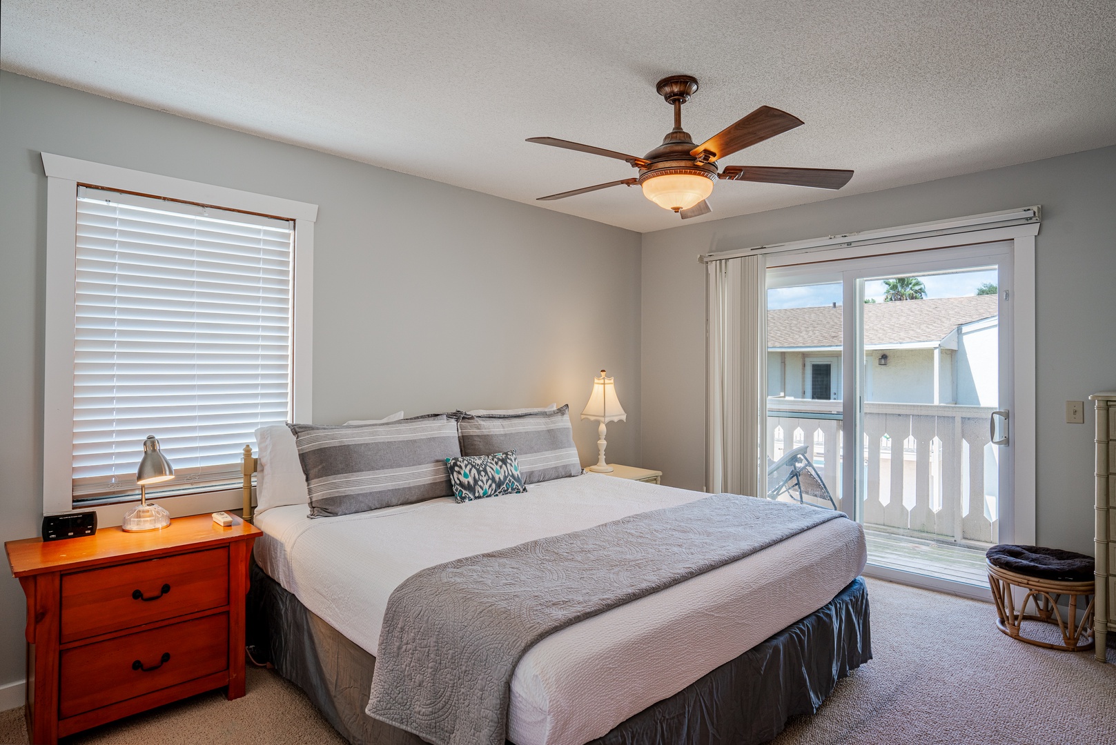 The king suite boasts a private ensuite, ceiling fan, TV, & balcony access