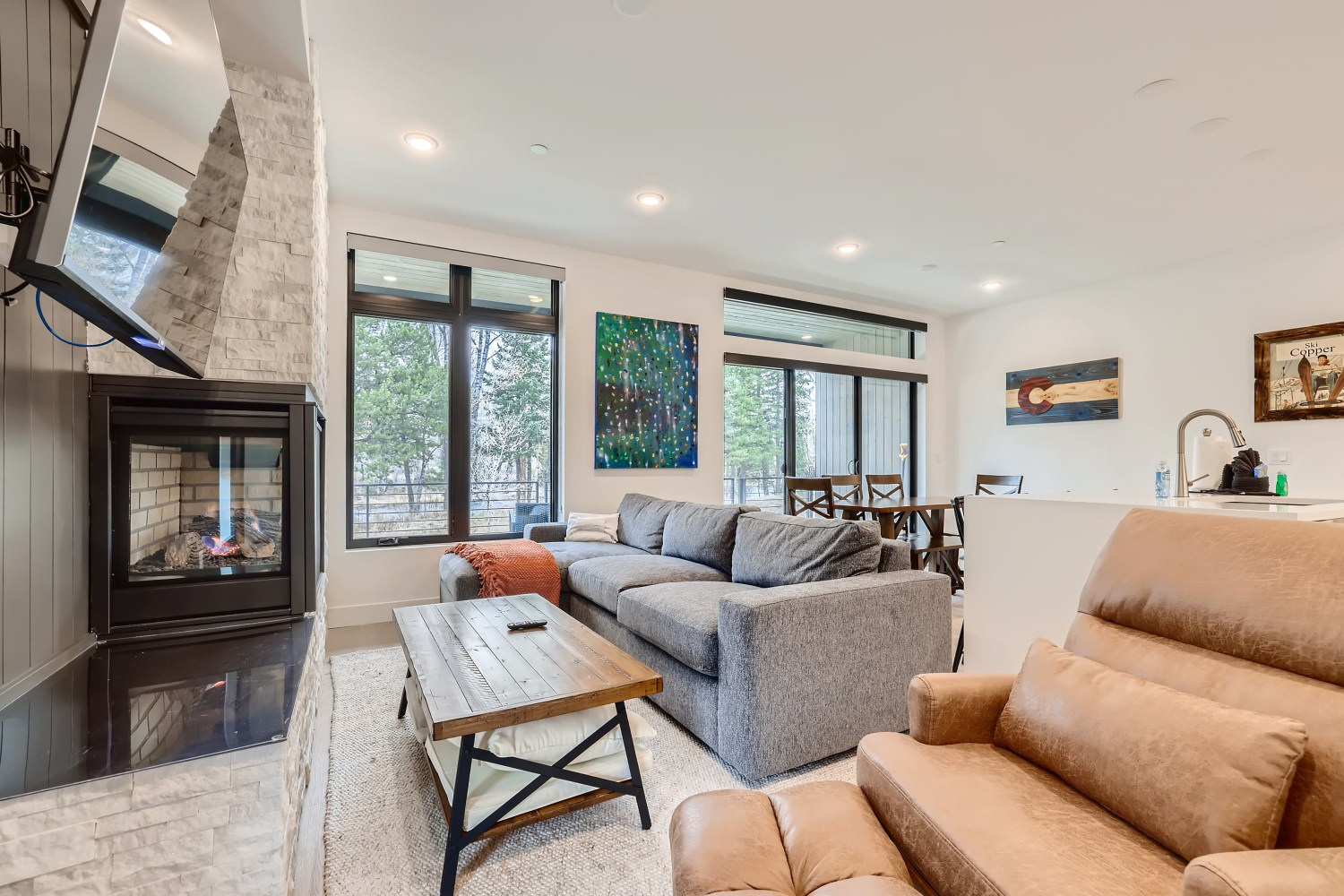 Open living space with gas fireplace, sofa sleeper, and Smart TV