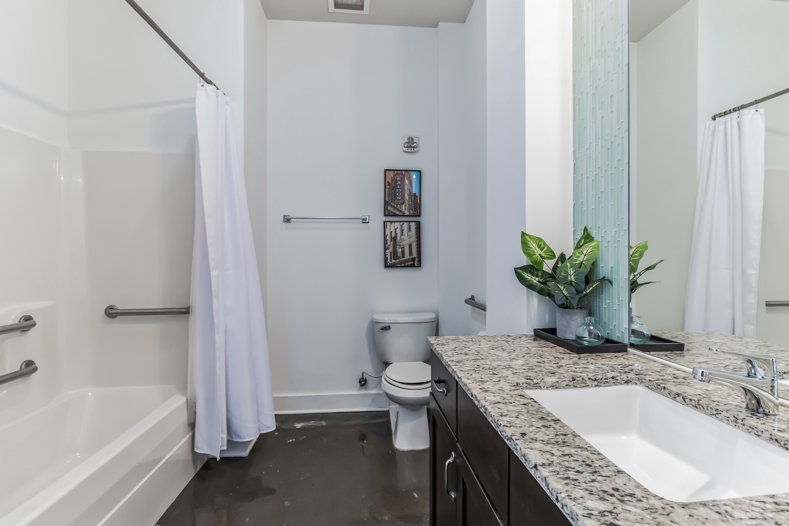 The primary bathroom boasts a spacious vanity and a combined shower/tub