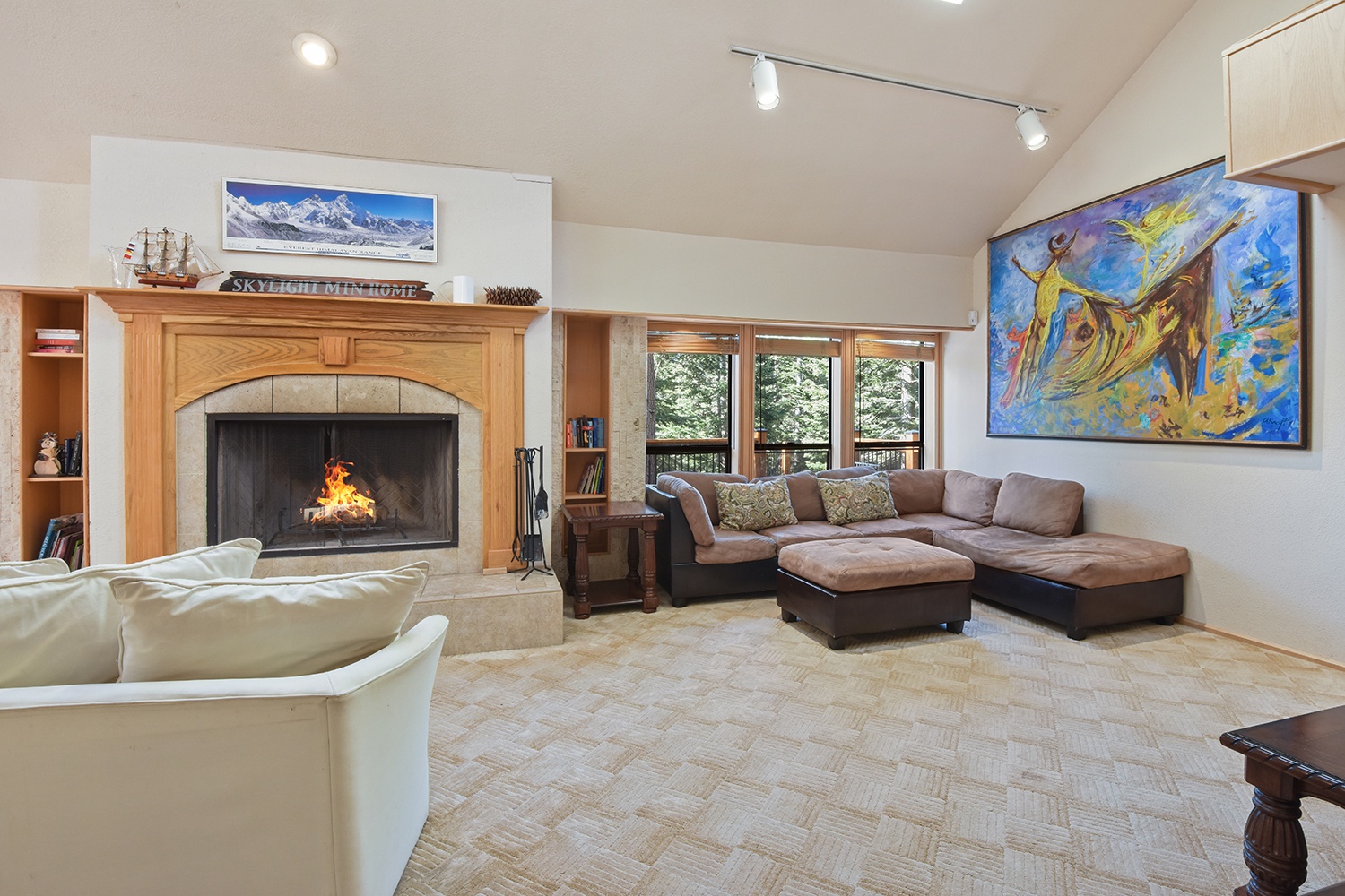 Open living space level 2 with fireplace, Smart TV, and deck