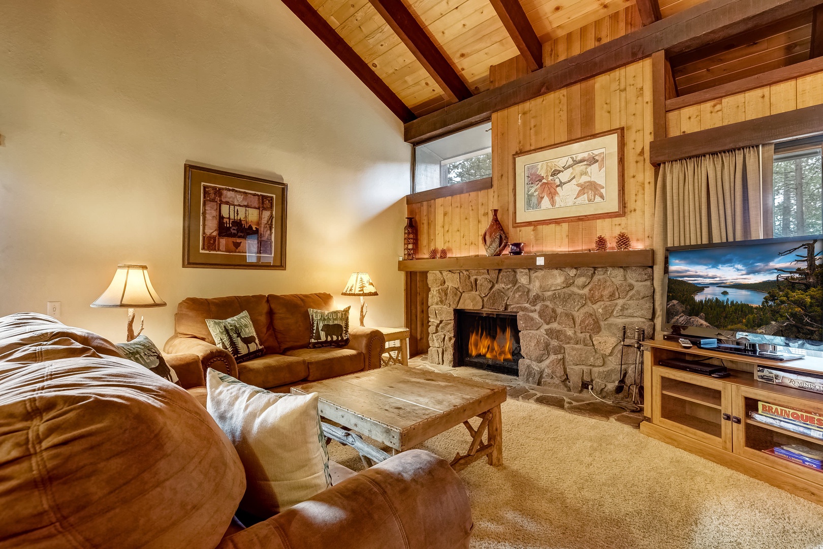 Living room w/ DVD player, flat screen TV, wood burning fireplace, board games