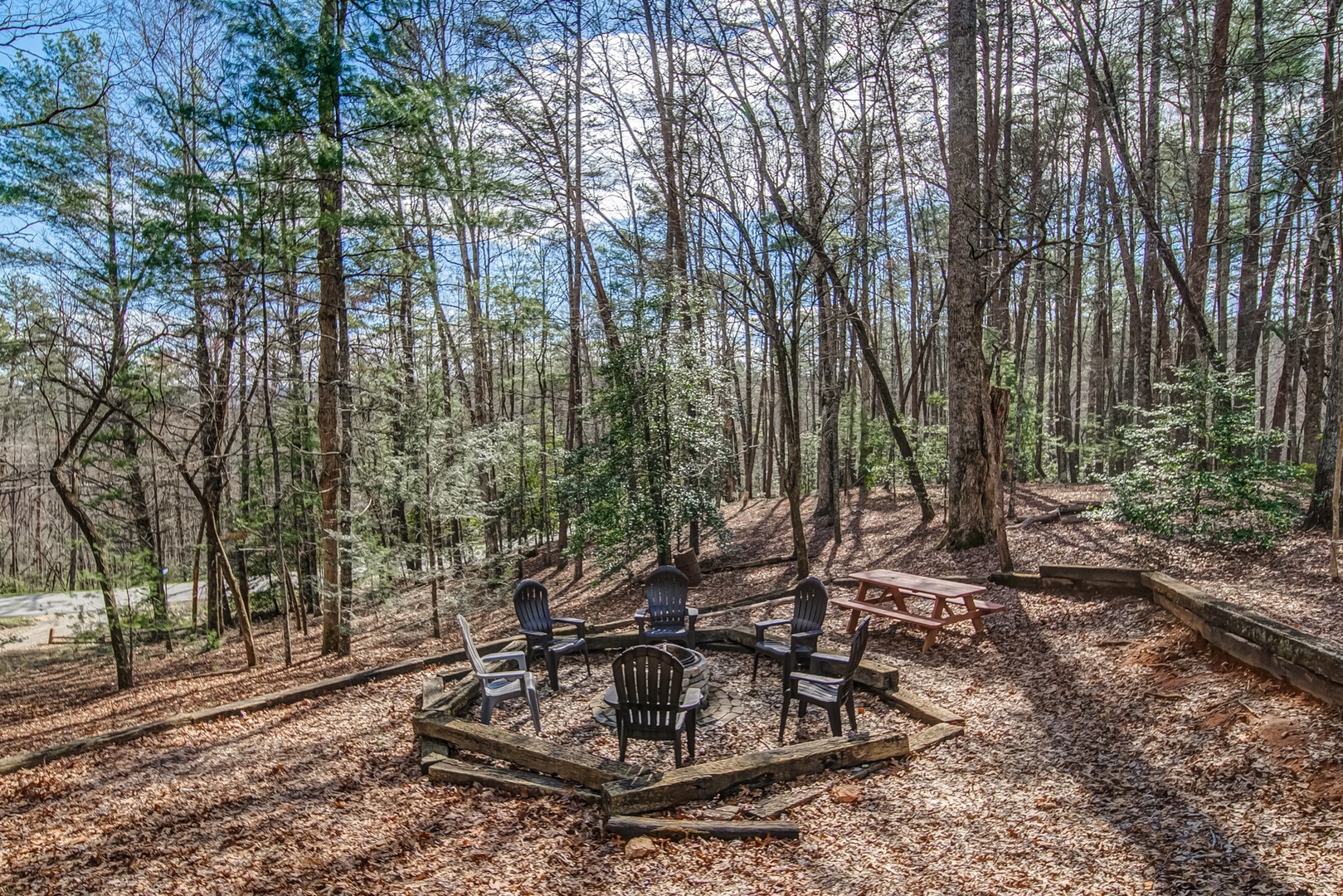 Toast marshmallows and swap stories in the extra large Firepit area with Picnic Table