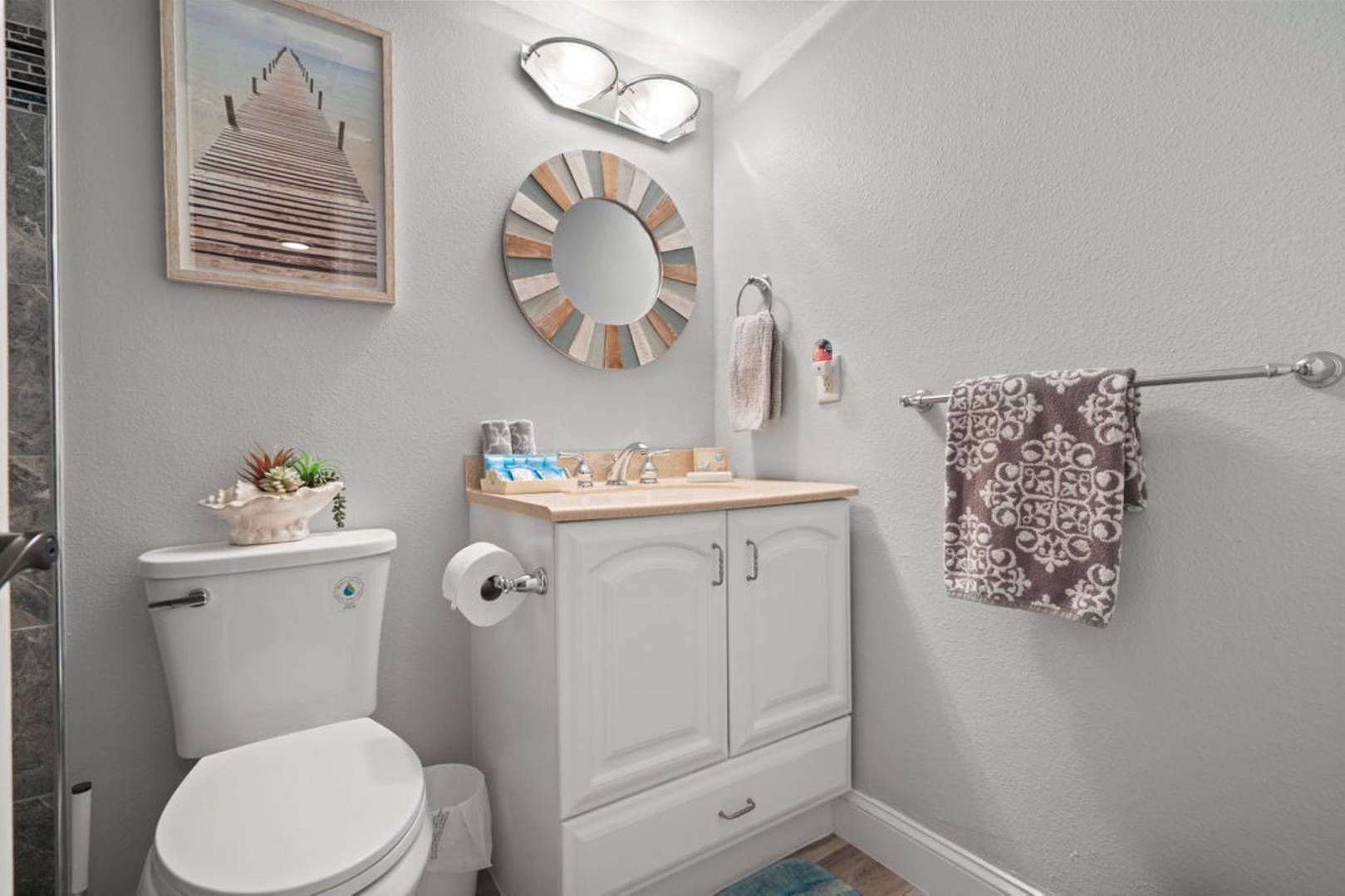 Modern shared bathroom featuring a walk-in shower with sleek glass doors