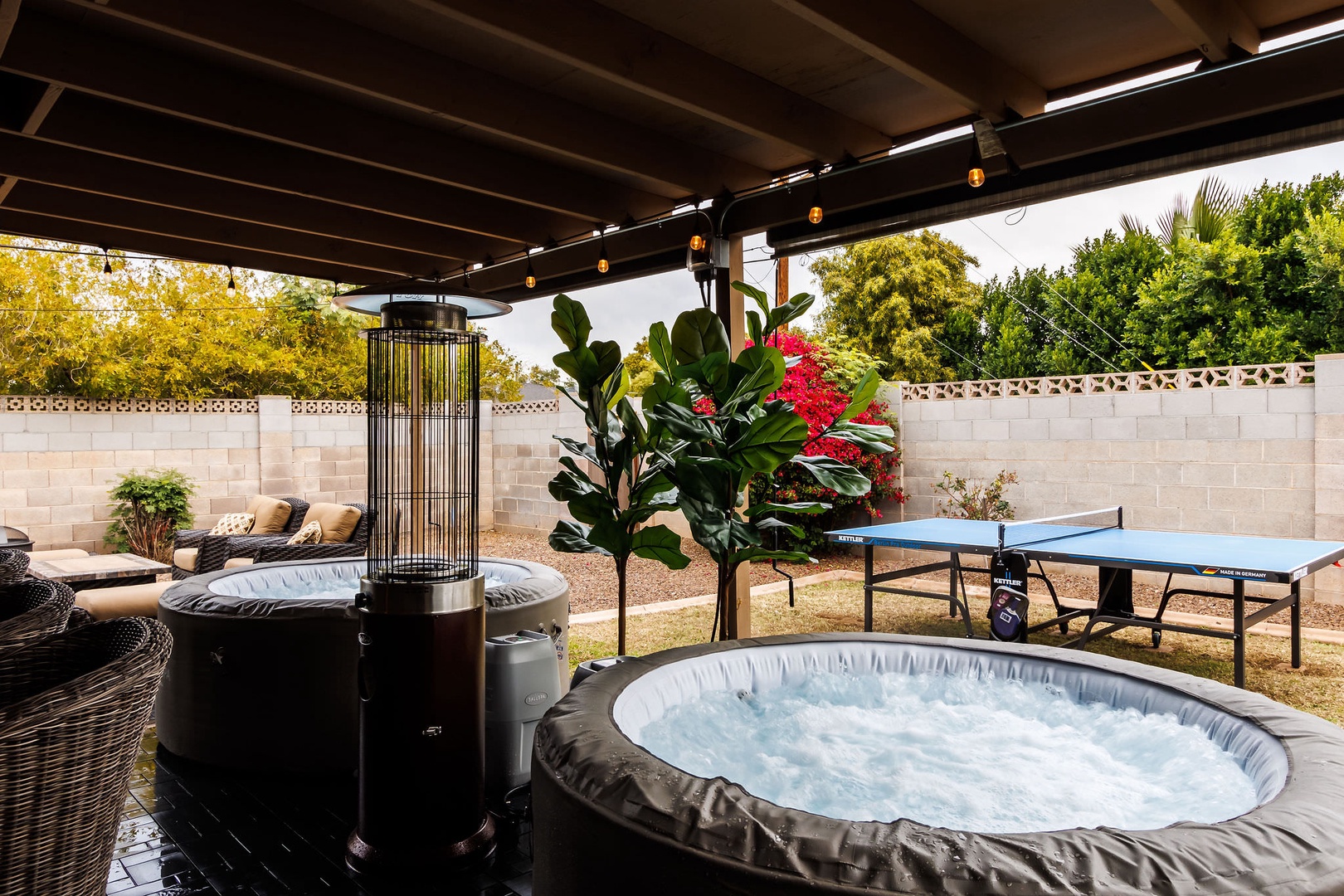 Patio with dual hot tubs & outdoor ping pong