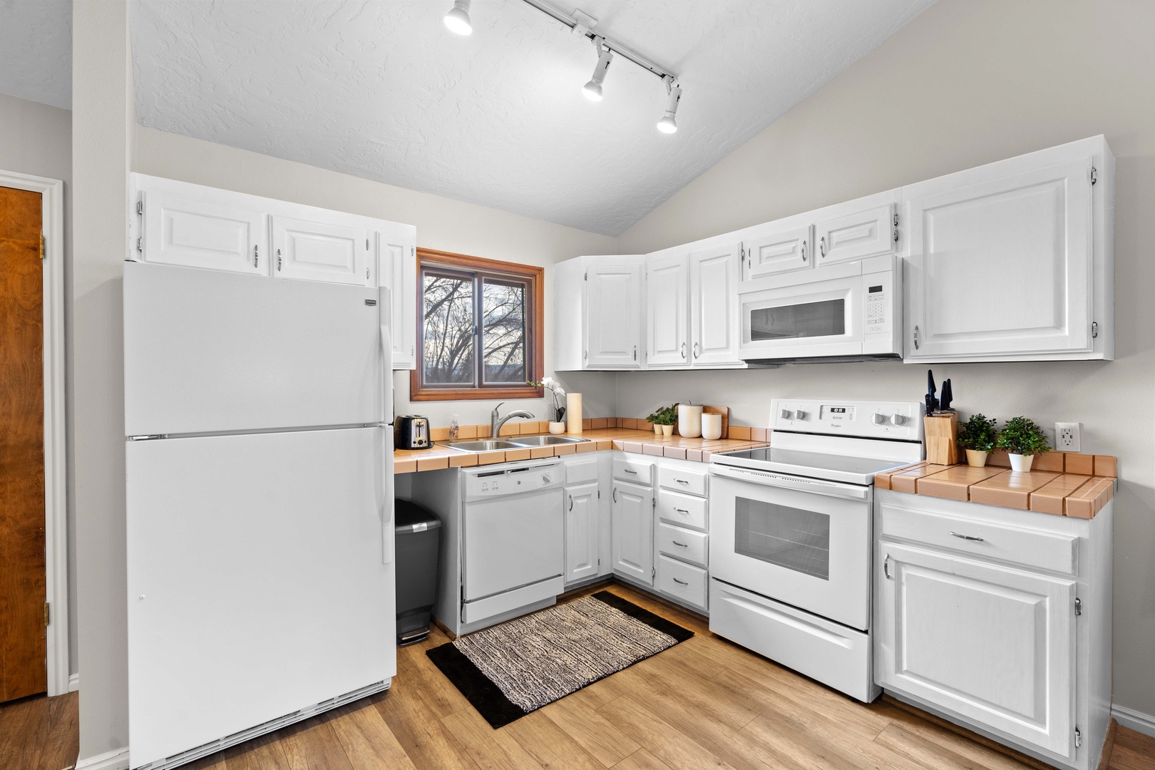 The airy, open kitchen offers ample space & all the comforts of home