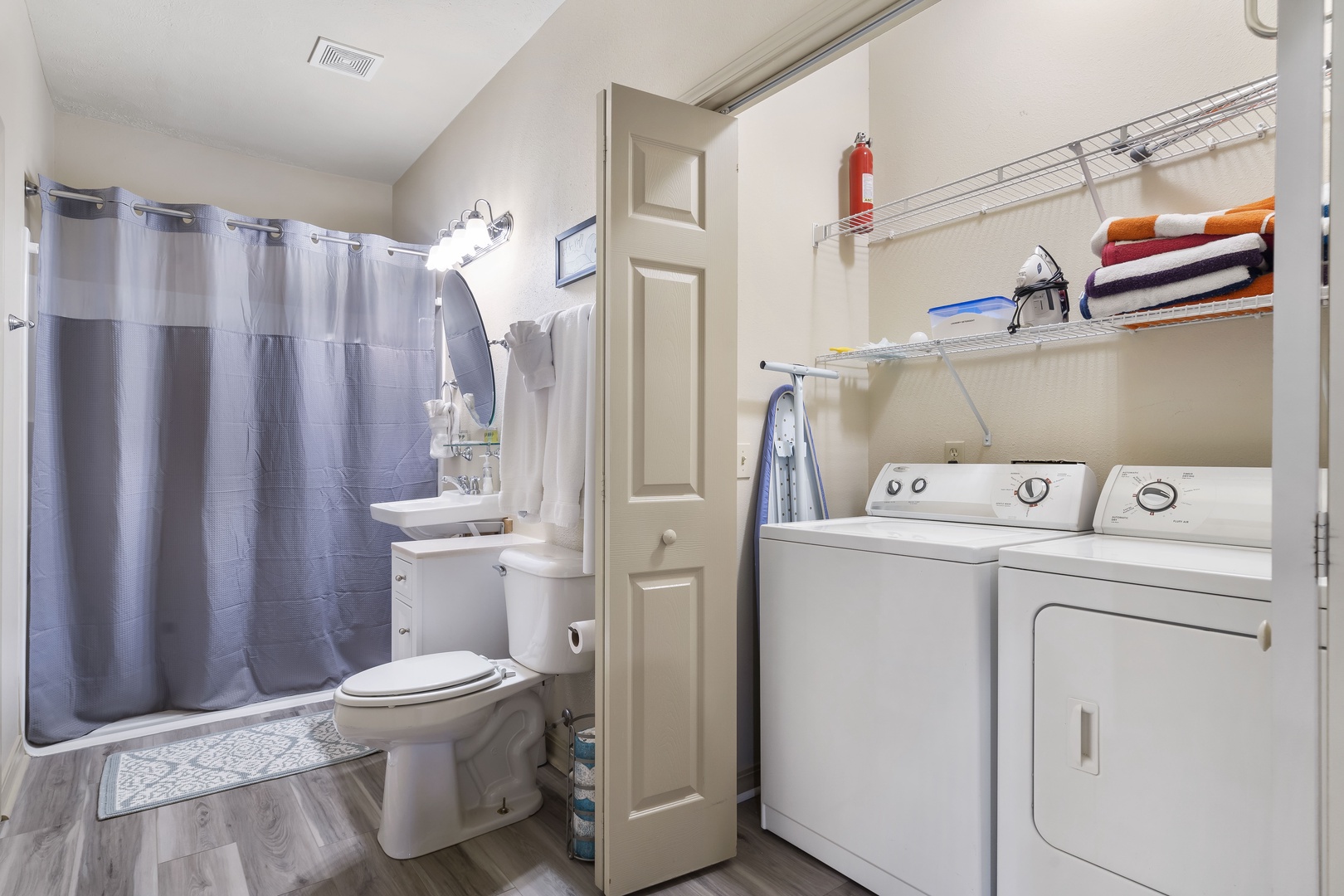 Bathroom 1 shared en-suite with walk-in shower, and laundry closet accessible from the living room
