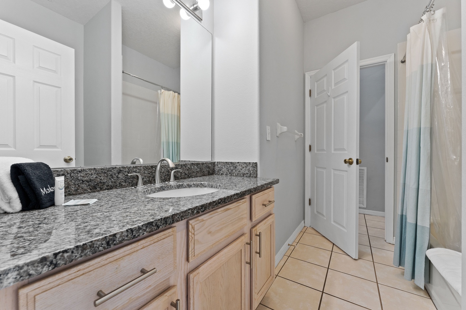 The shared full bathroom includes a large single vanity & shower/tub combo