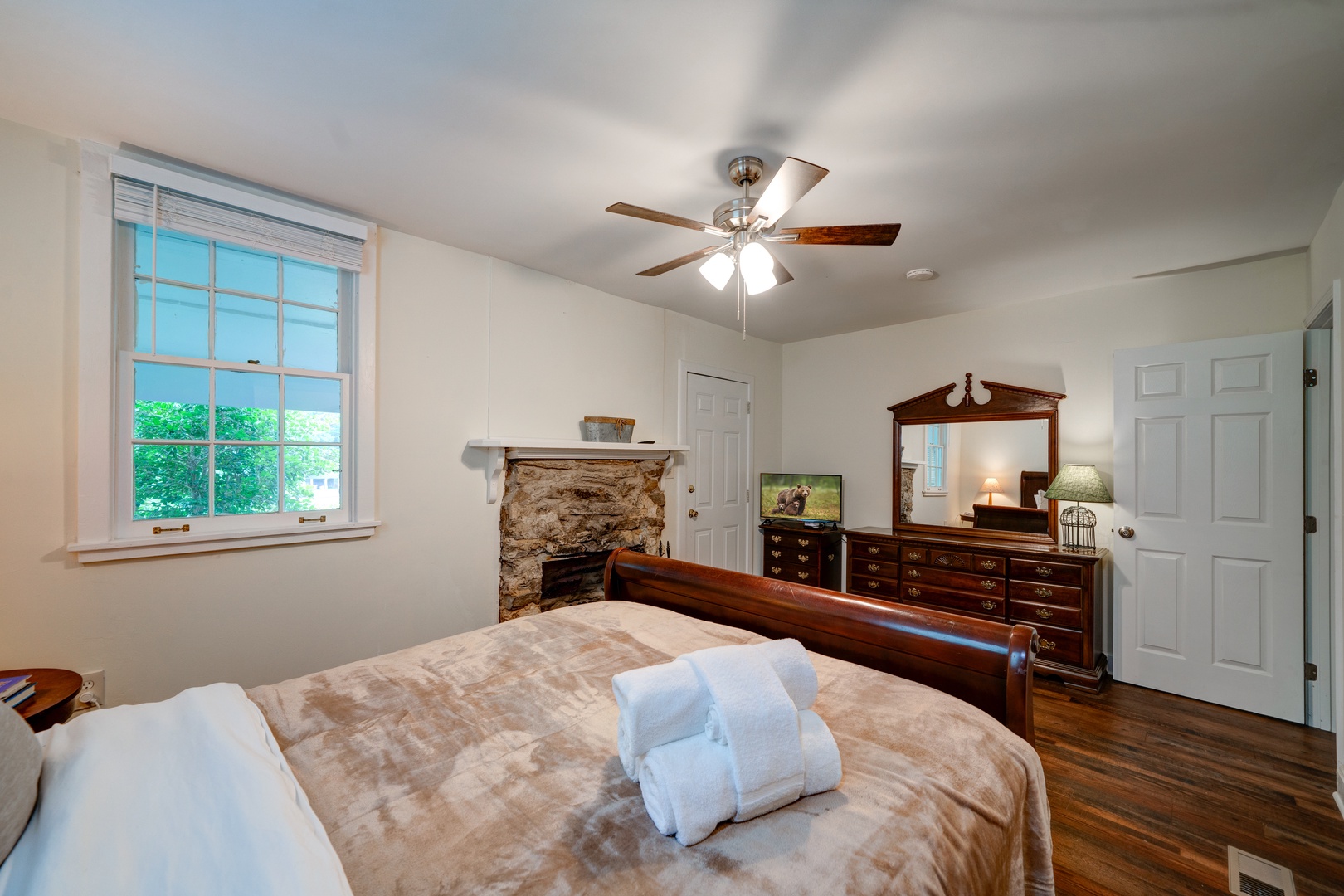 The master suite boasts a queen bed, ensuite bath with laundry, & porch access