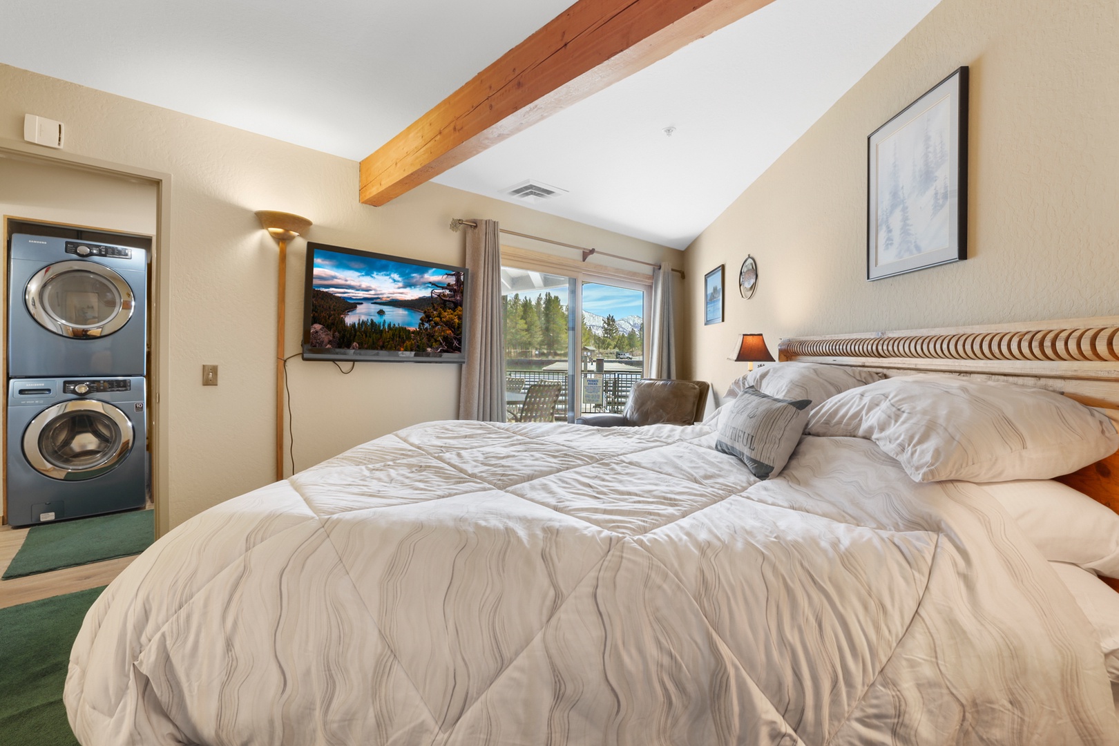 Bedroom 1 with queen bed, Smart TV, deck, and ensuite