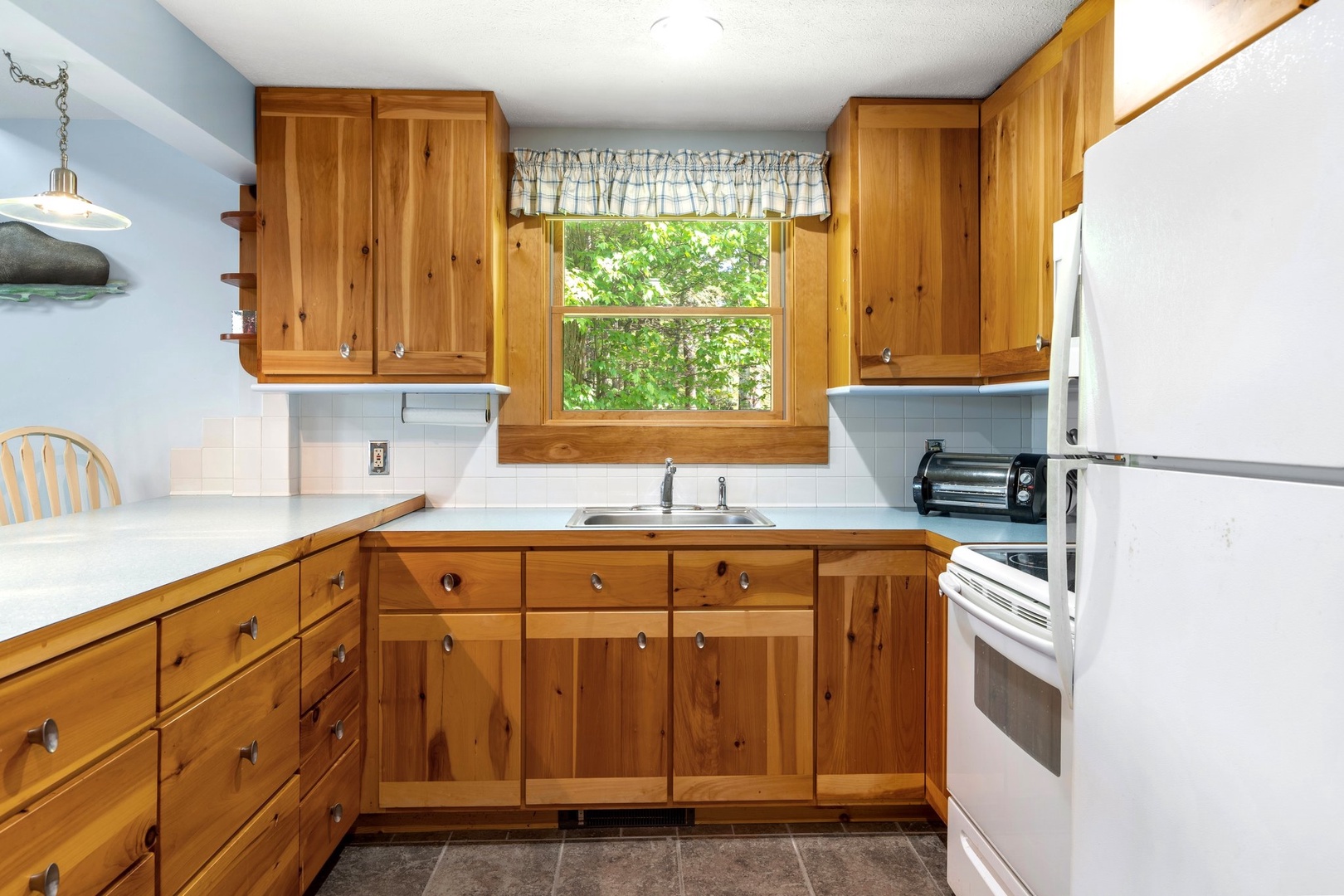 This open, airy kitchen offers ample space & all the comforts of home