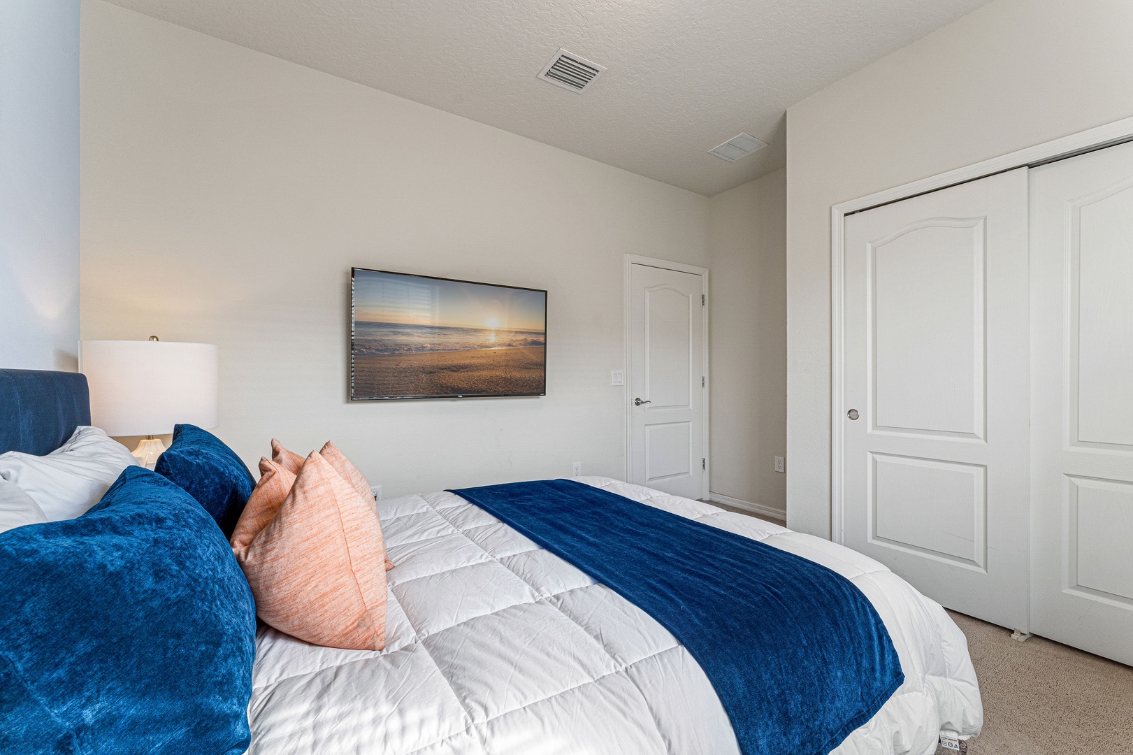 This cozy queen bedroom includes a smart TV & closet storage