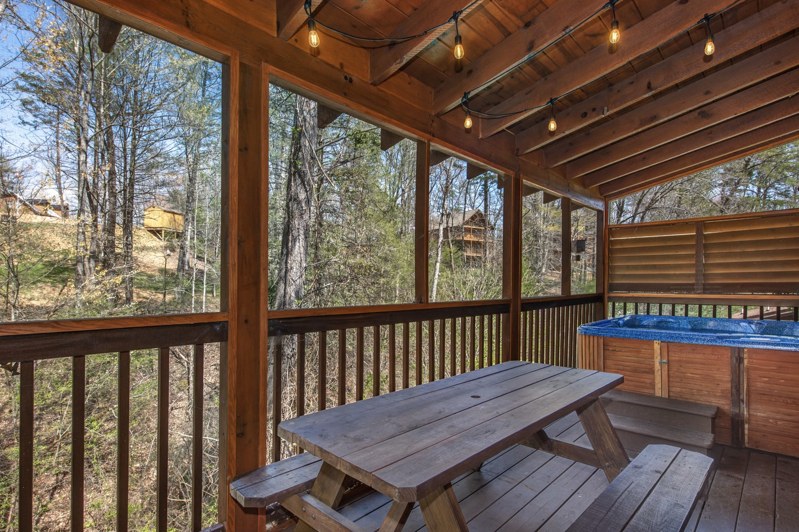 Outdoor deck with picnic table area next to hot tub