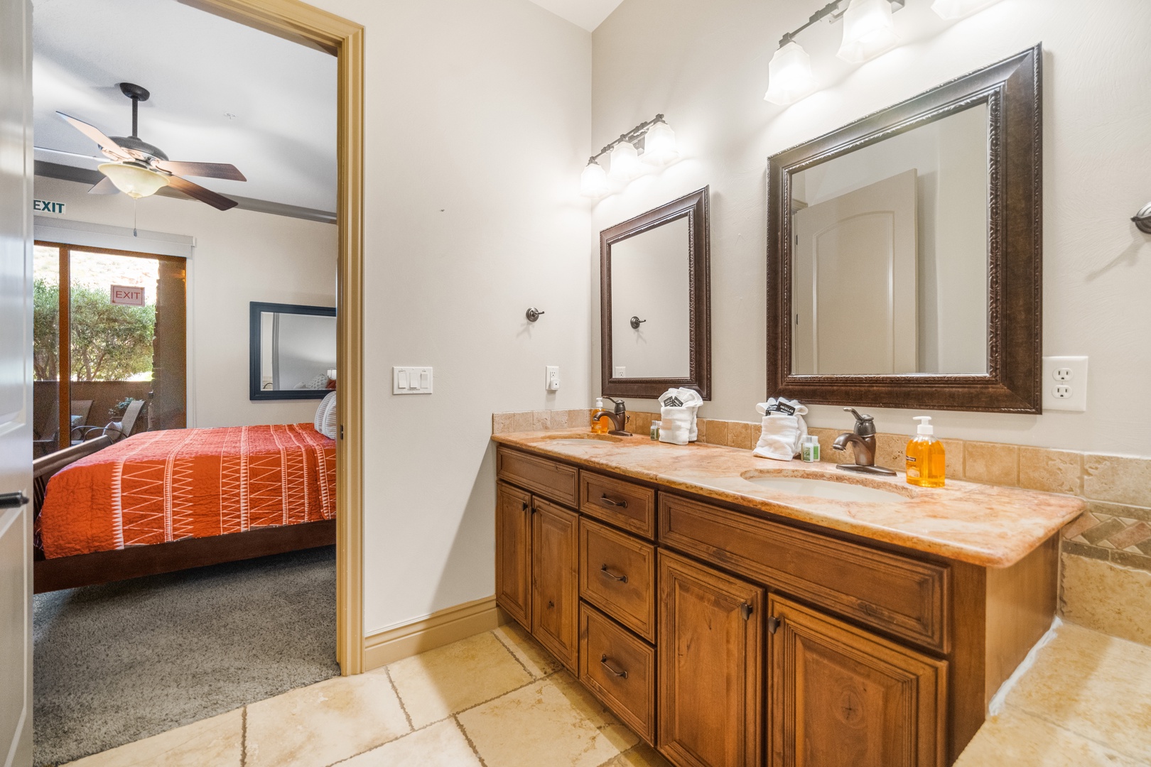 The primary ensuite showcases a dual sink, soaking tub & walk-in shower