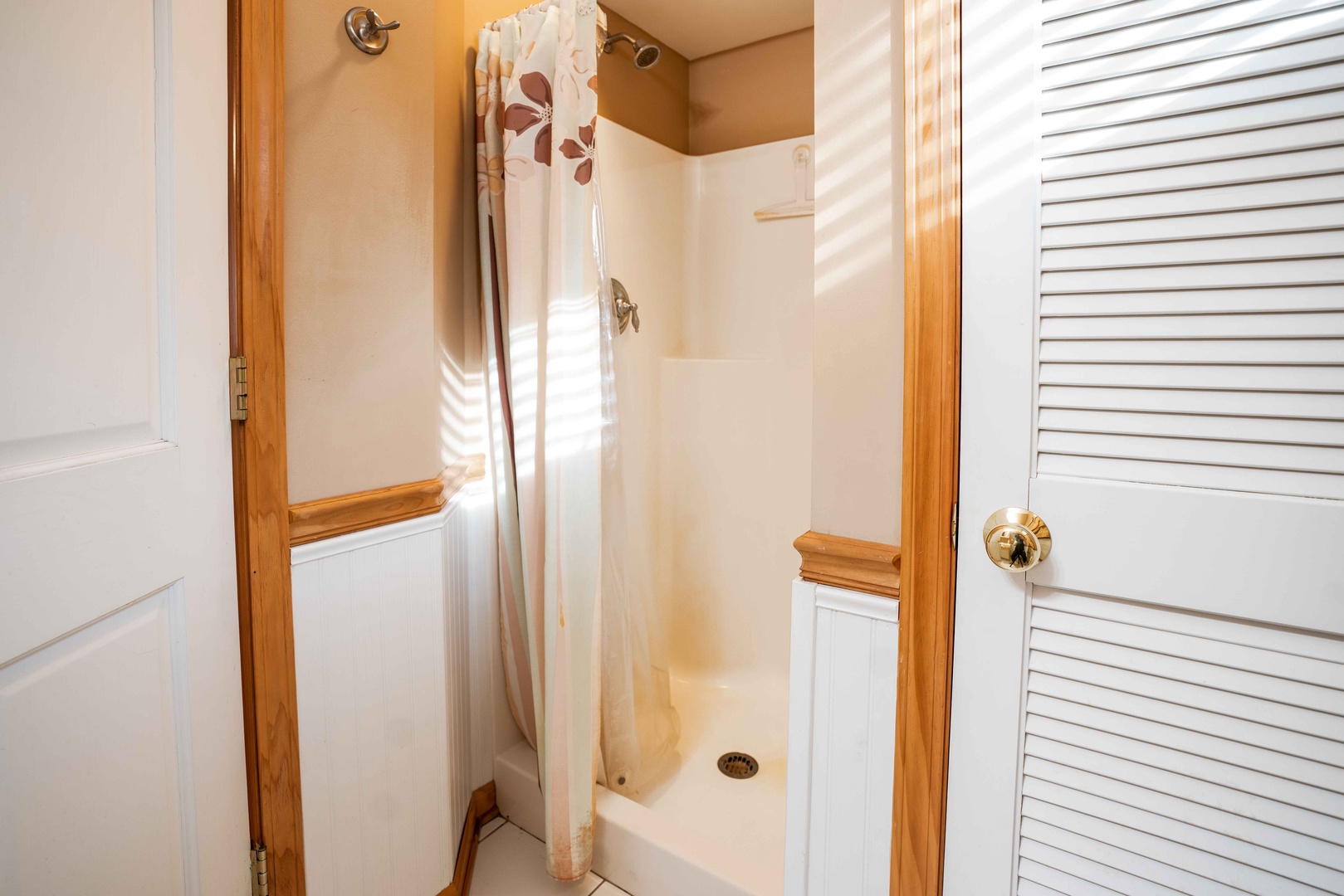 This full bath in the guest house offers a walk-in shower & single vanity