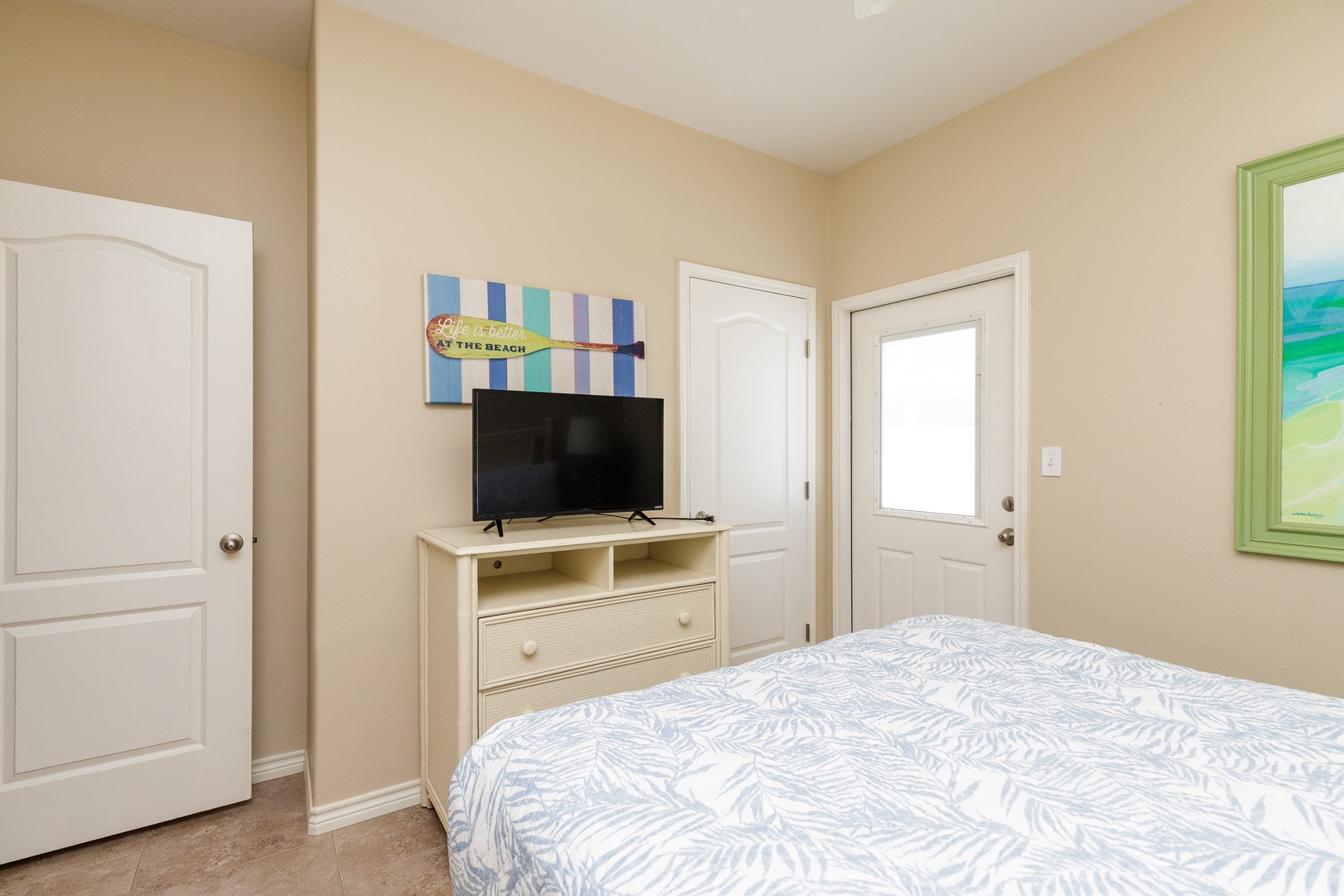 Bedroom 2 with Queen bed, Smart TV, and exterior access