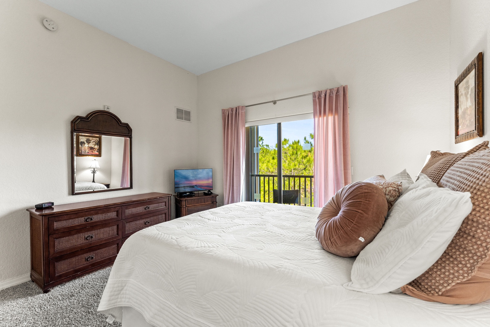 Recharge in this cozy queen bedroom, featuring balcony access
