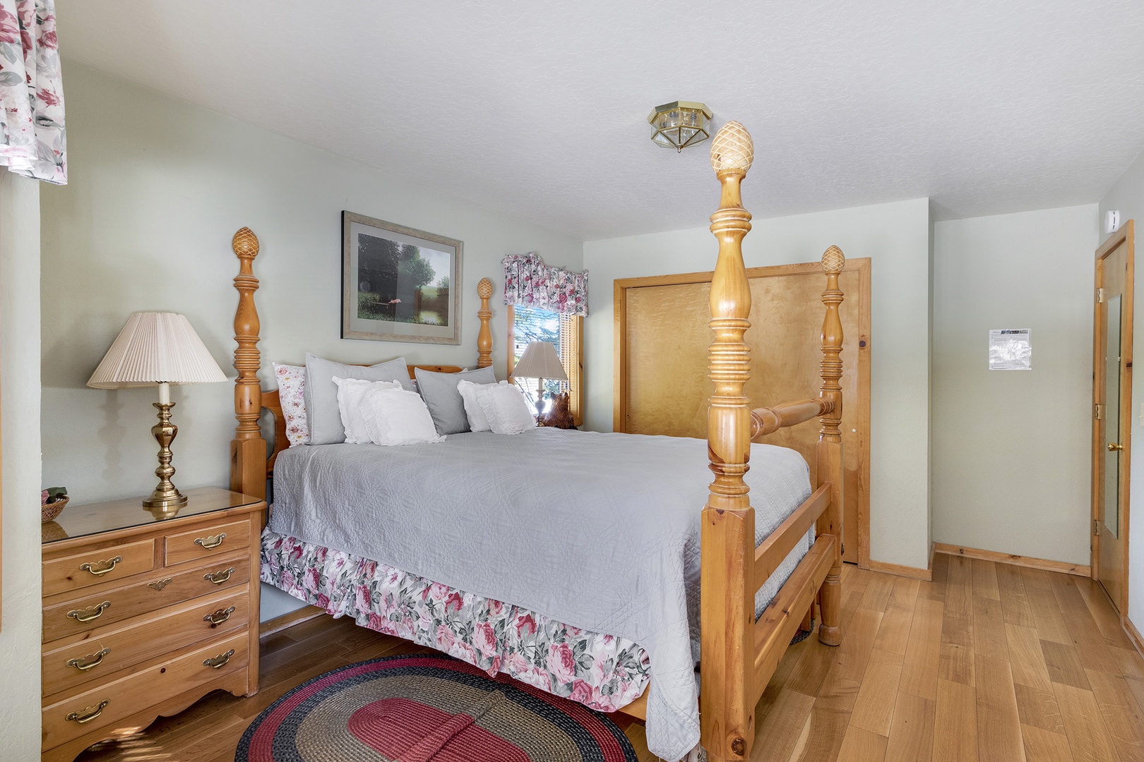 This bedroom retreat features a comfortable queen-size bed and a cozy reading chair