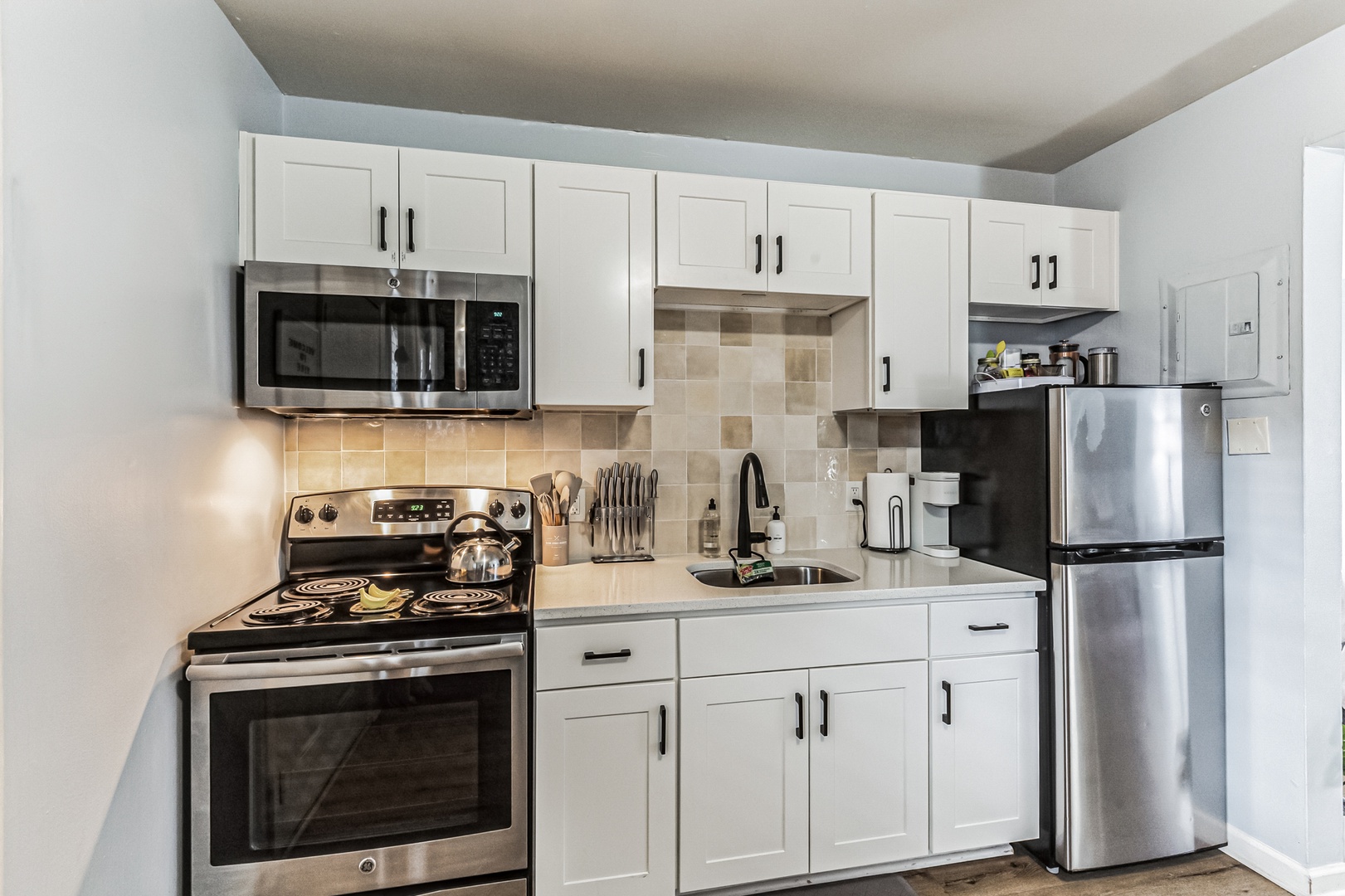 Modern kitchen with stainless steel appliances and ample storage.