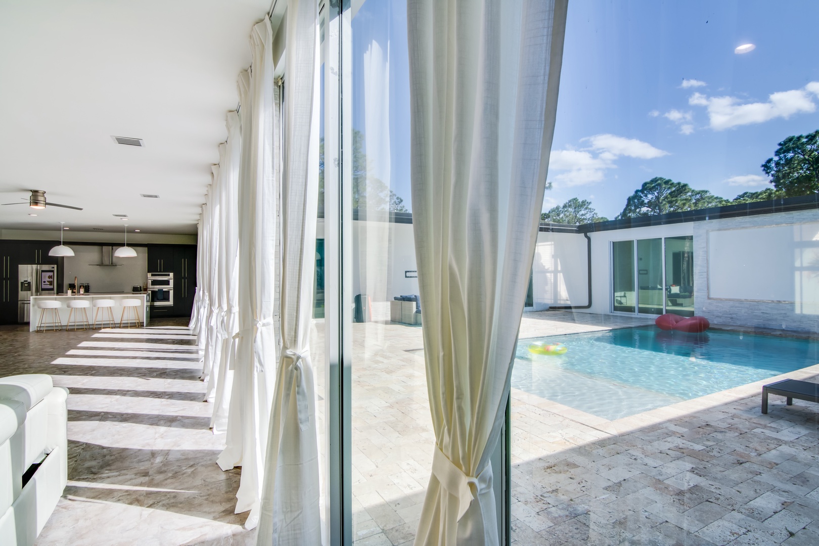 Floor-to-ceiling glass windows in the living area