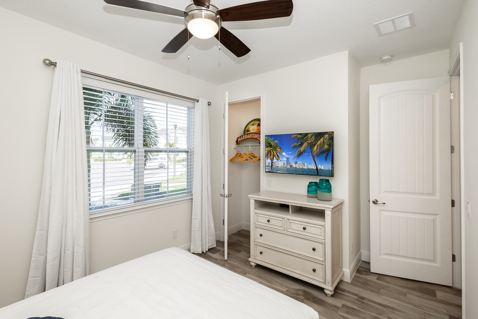 The 1st floor queen bedroom offers a TV & ceiling fan