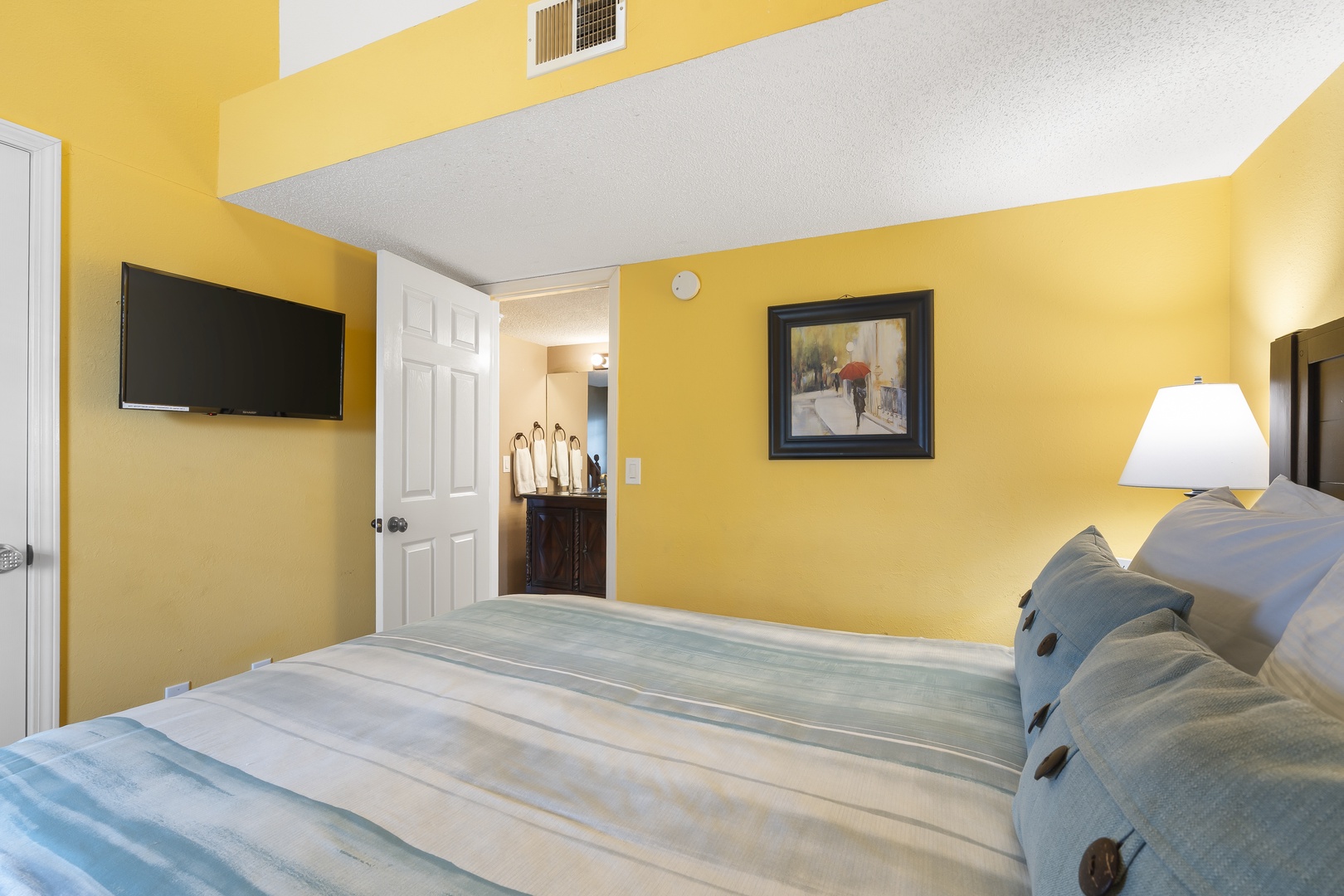 The cheerful main-level queen suite features a private ensuite & Smart TV