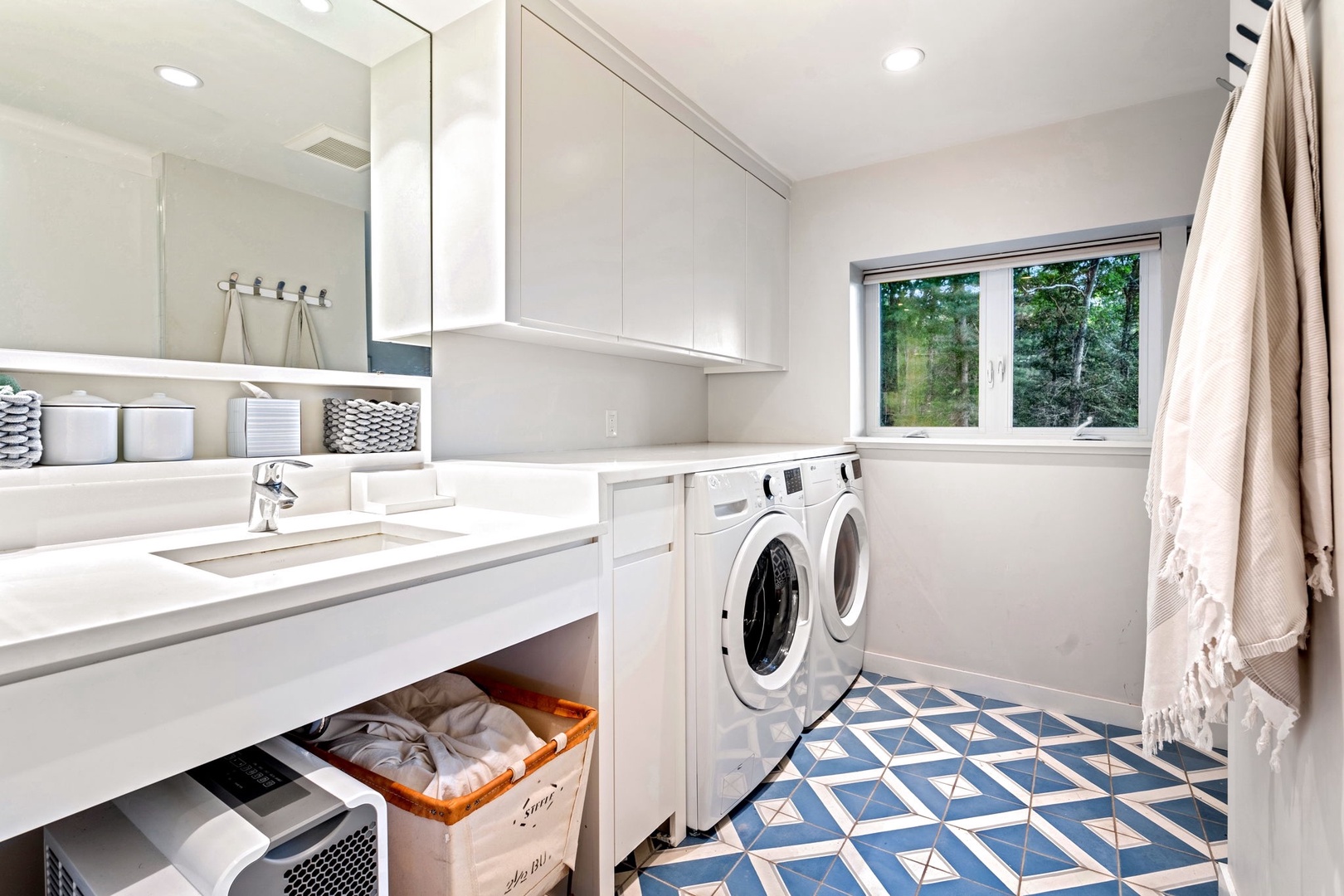 This basement bathroom features a walk-in shower and handy washer/dryer