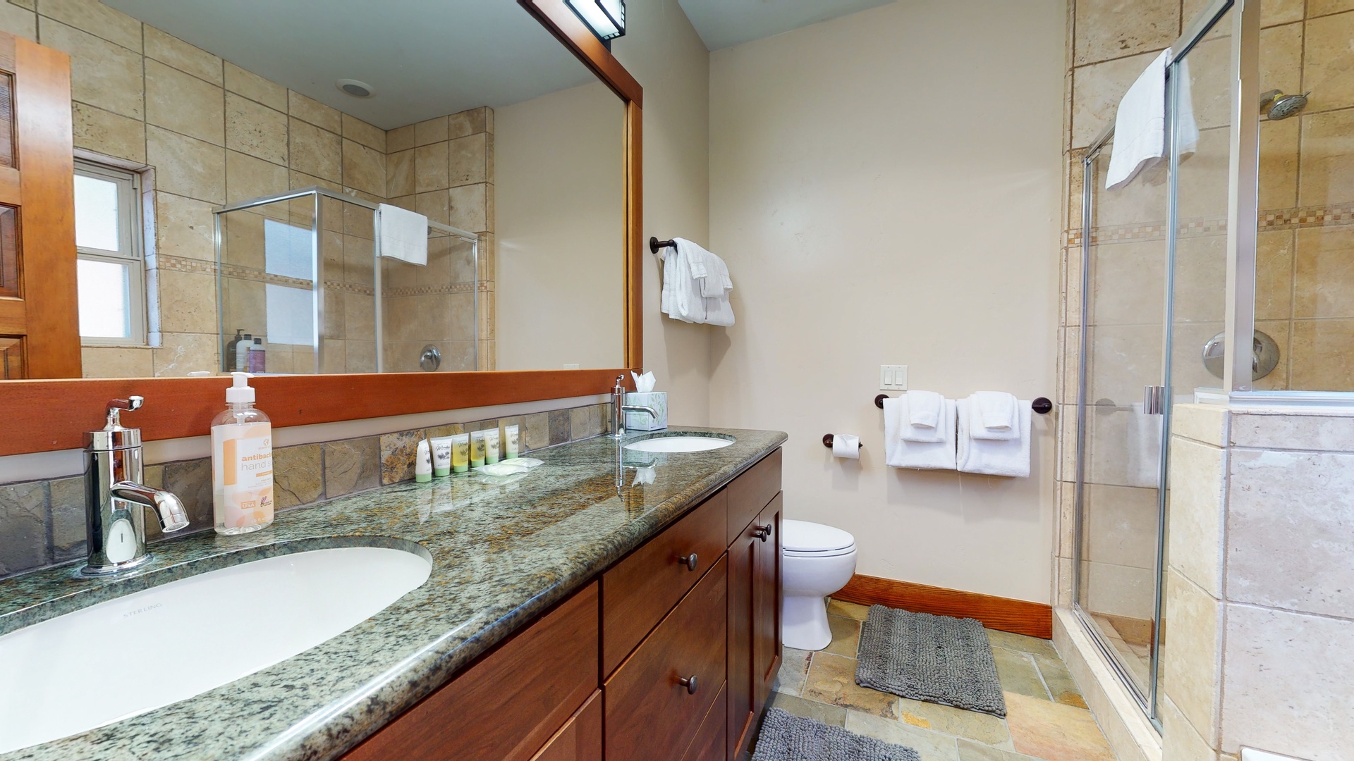 En suite bathroom with soaking tub, standing shower and dual sinks