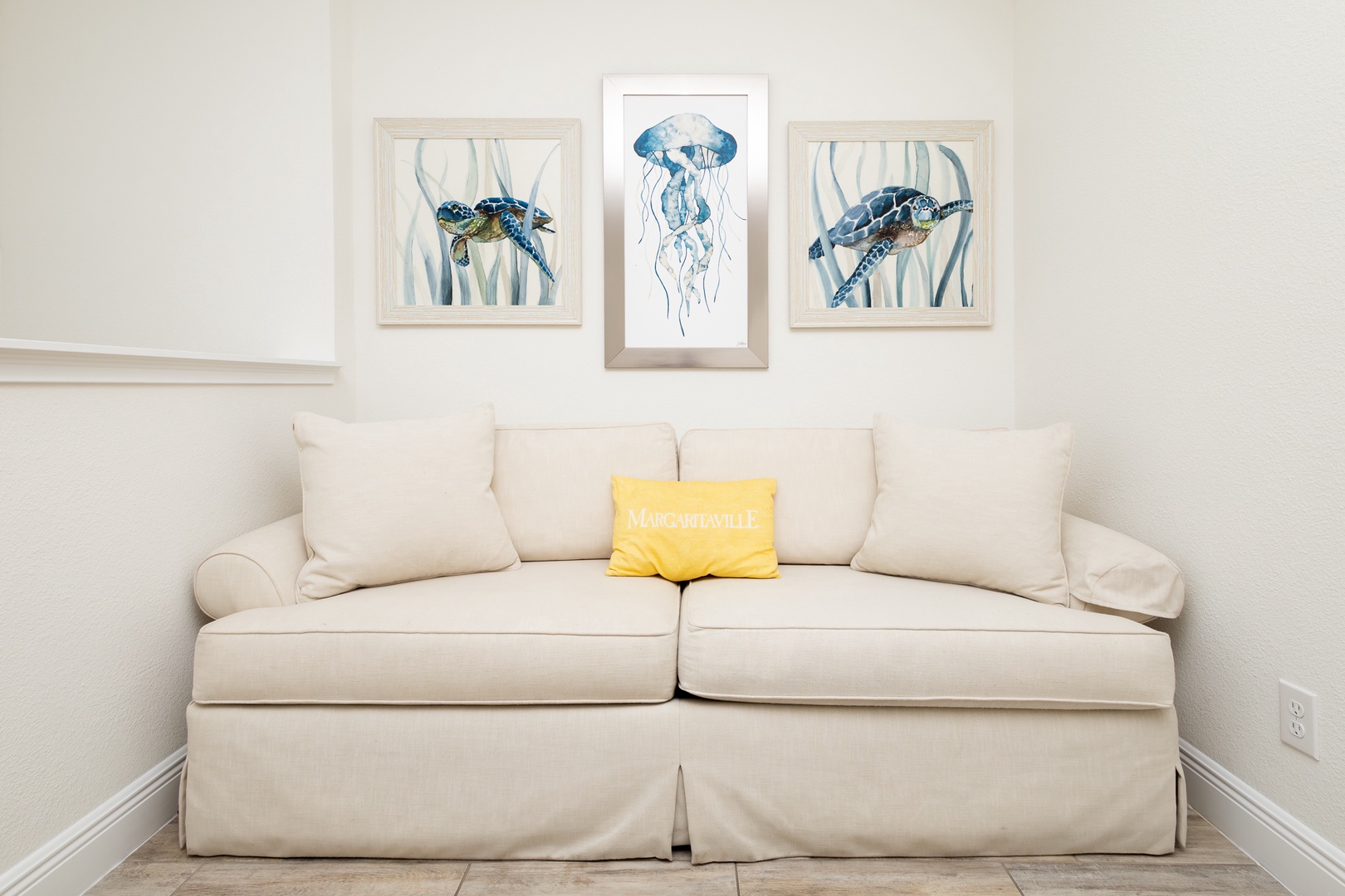 The 2nd floor loft features a sleeper sofa and oceanic decor