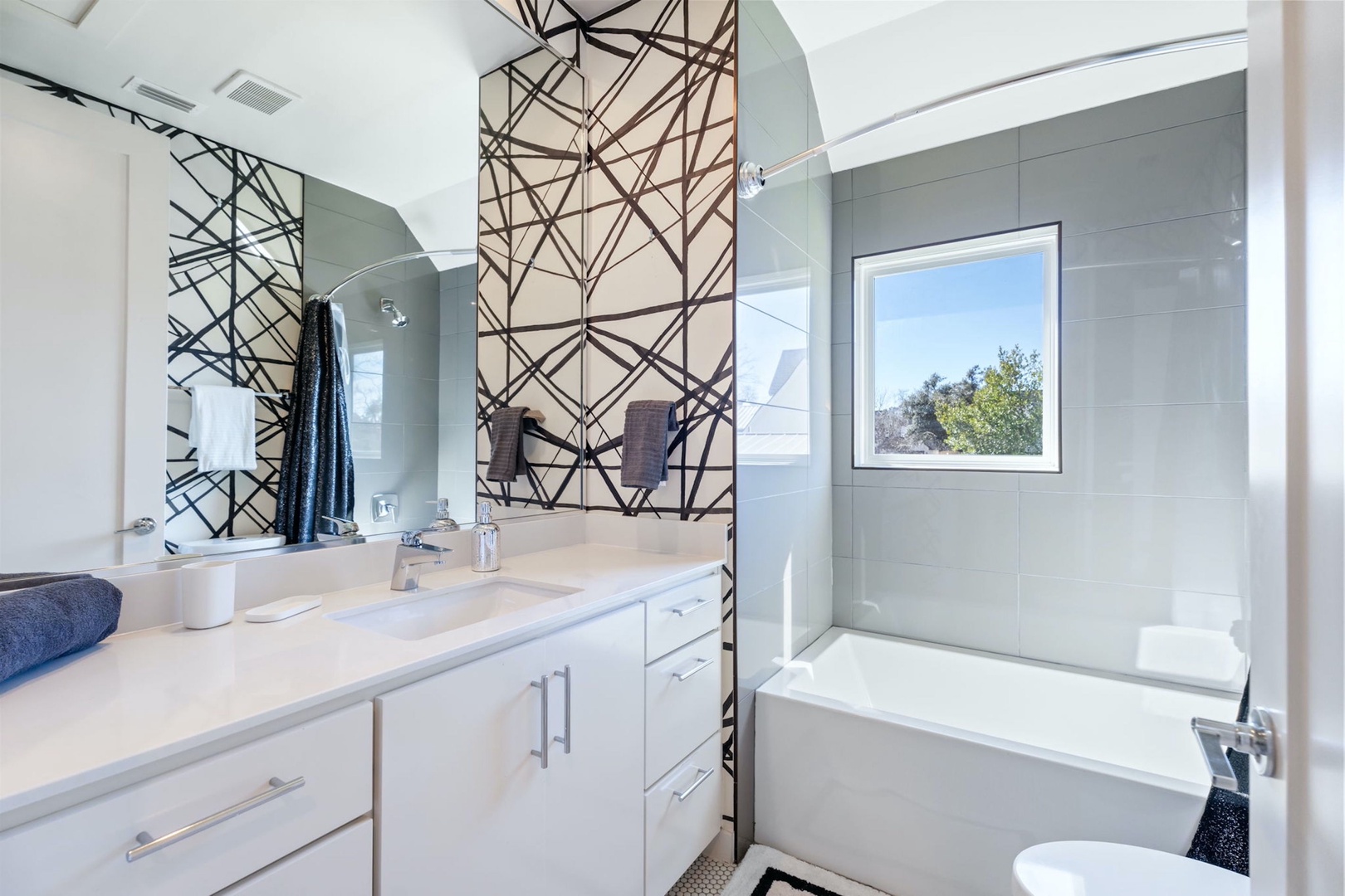 The 2nd-floor full bath features a spacious single vanity & shower/tub combo