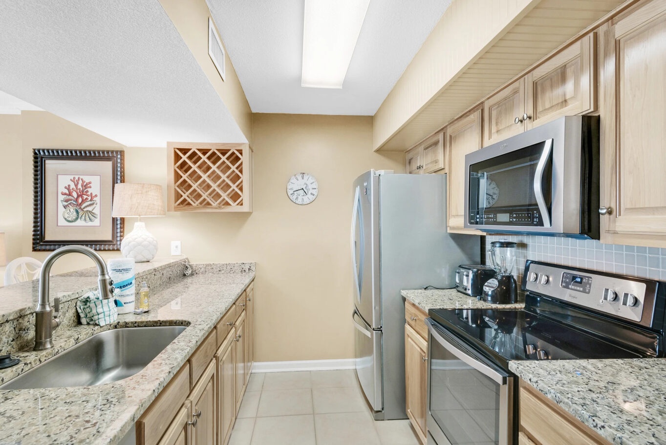 The sunny kitchen offers amply space & all the comforts of home