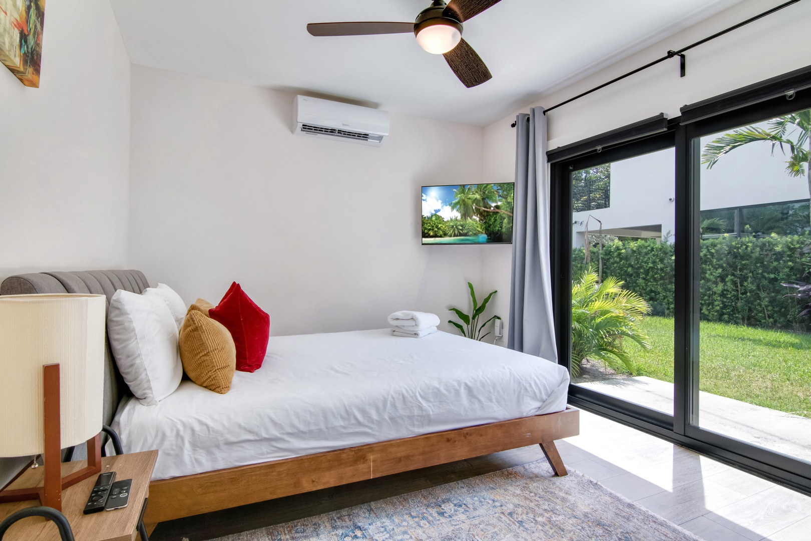 Main House: Bedroom 4 with queen bed, Smart TV, patio access, and ensuite