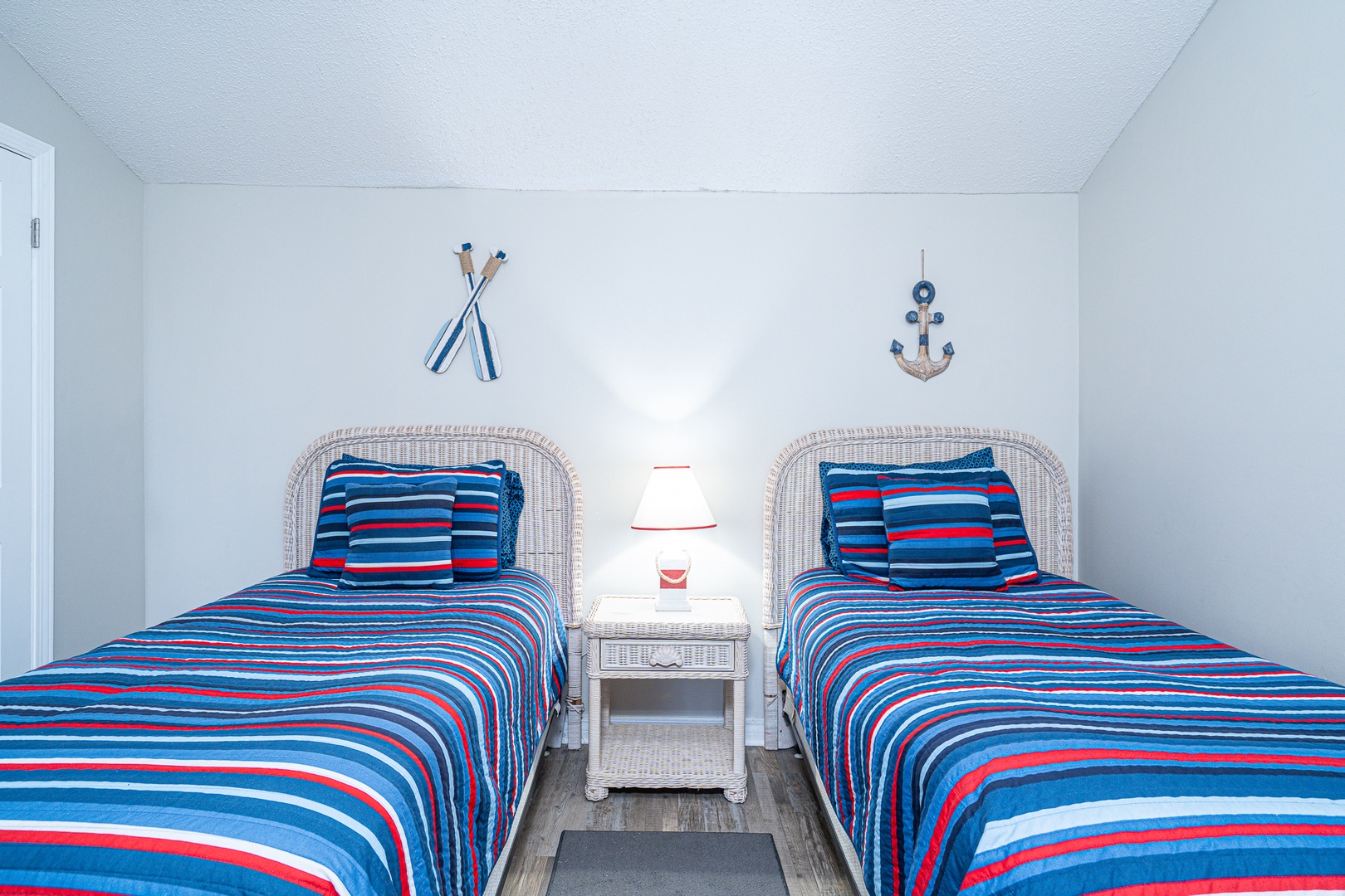 The upstairs loft sleeping area showcases a pair of cozy twin-sized beds