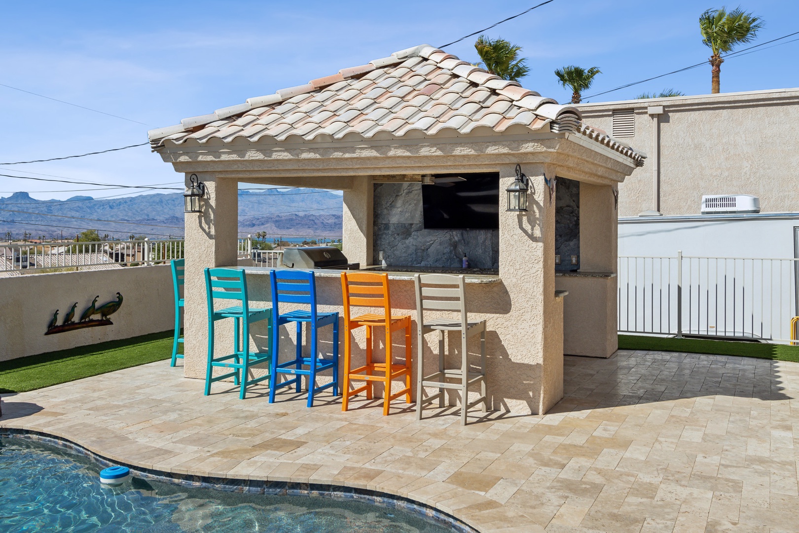 A mountain-view oasis, with a waterfall pool, hot tub, & outdoor kitchen!