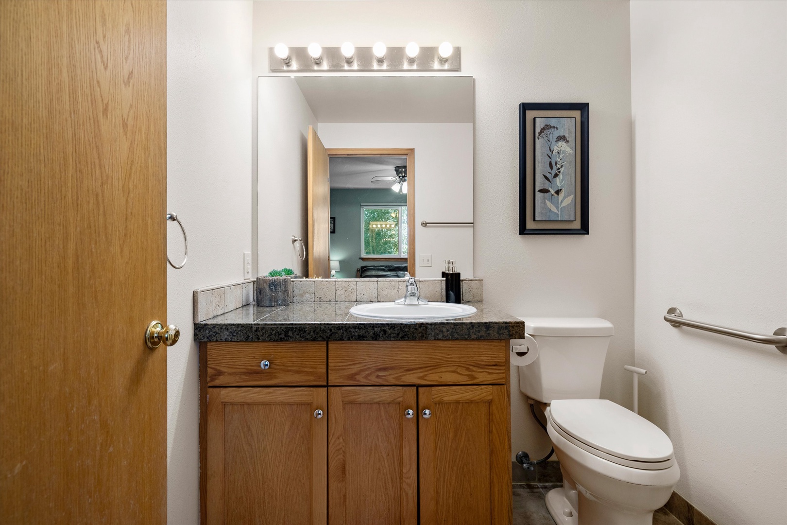 A single vanity & ADA-accessible shower await in the ensuite bath